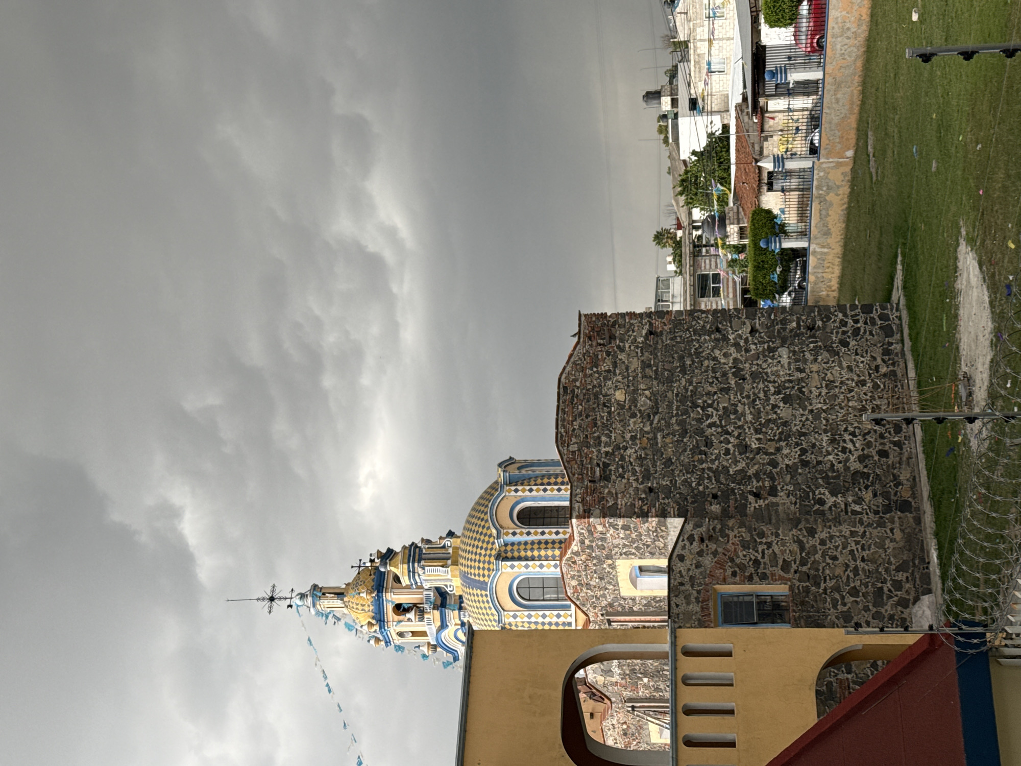 Evening life captured in Mexican town: church, children drawing