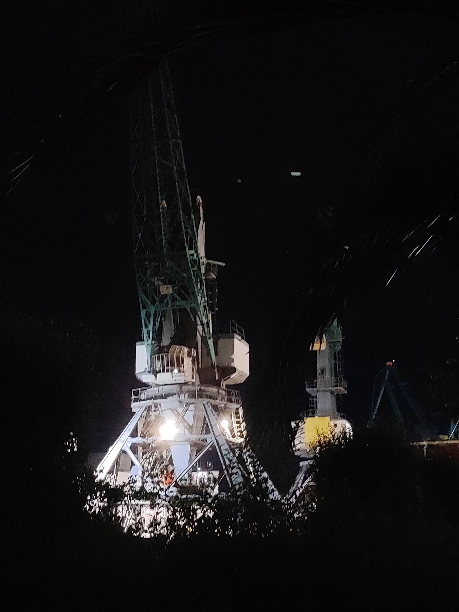 Batumi port district at night, cranes to café signs