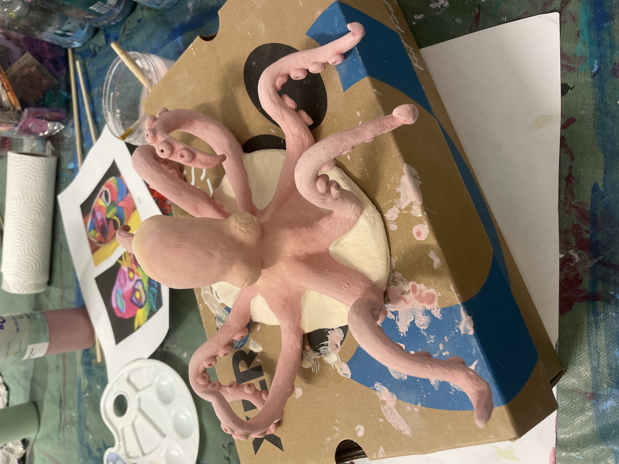 Pink clay octopus sculpture spotted on cardboard box in Raanana