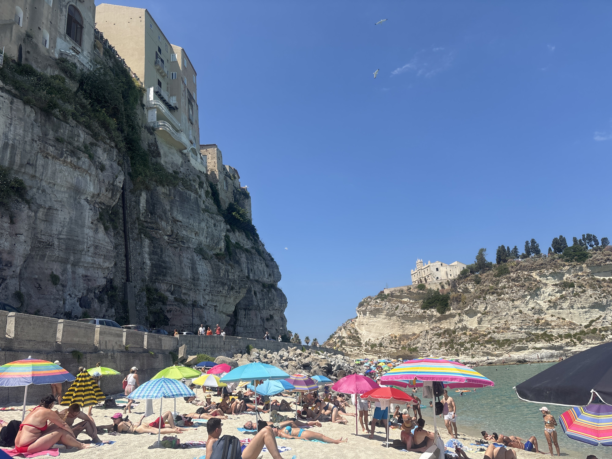 Crowded summer beach day in Tropea, Italy