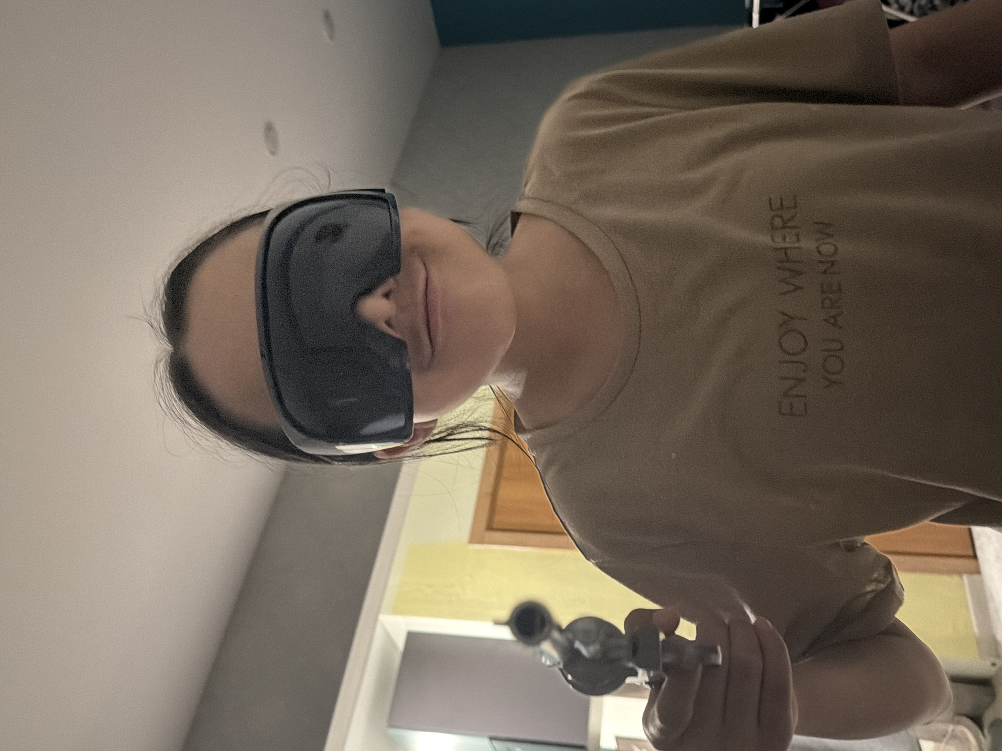 Person in sunglasses with glass pipe observed resting indoors