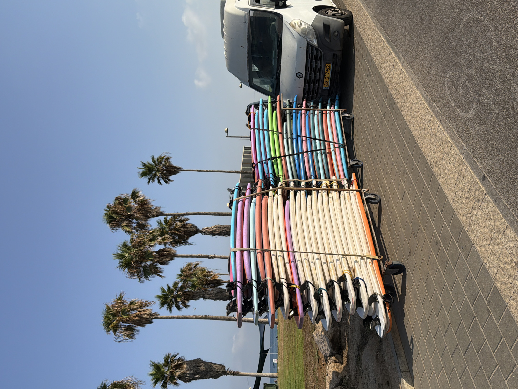 Surfboards being loaded up on a Tel Aviv beach morning