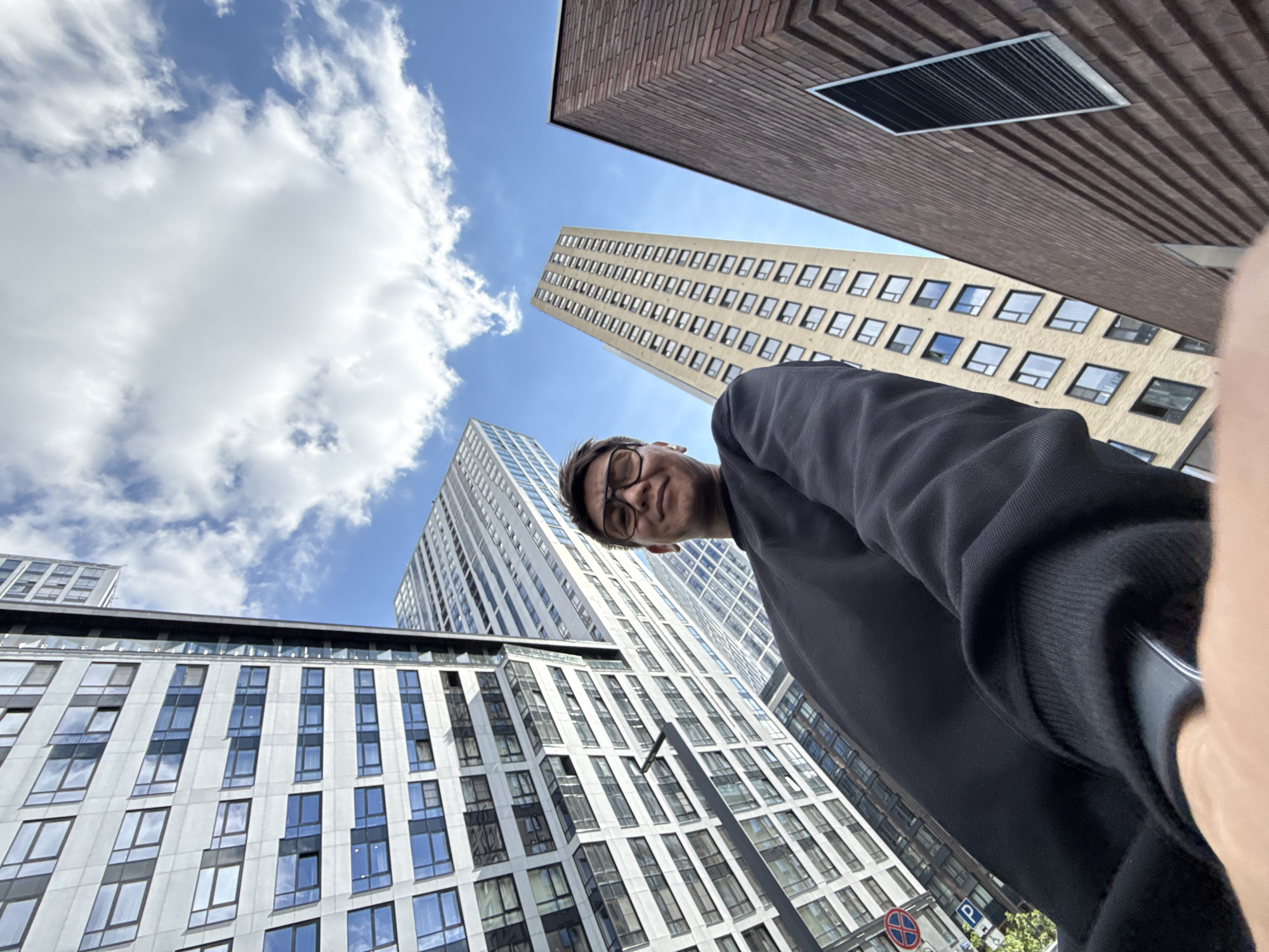 Low-angle selfies at a modern Moscow plaza