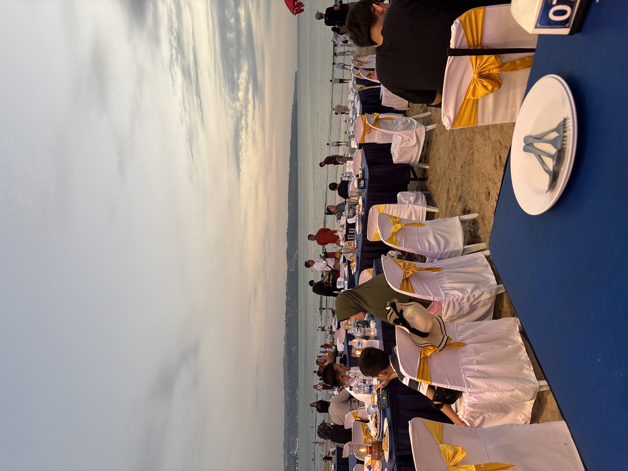 Elaborate beachfront dining setup at dusk in Kuta, Bali