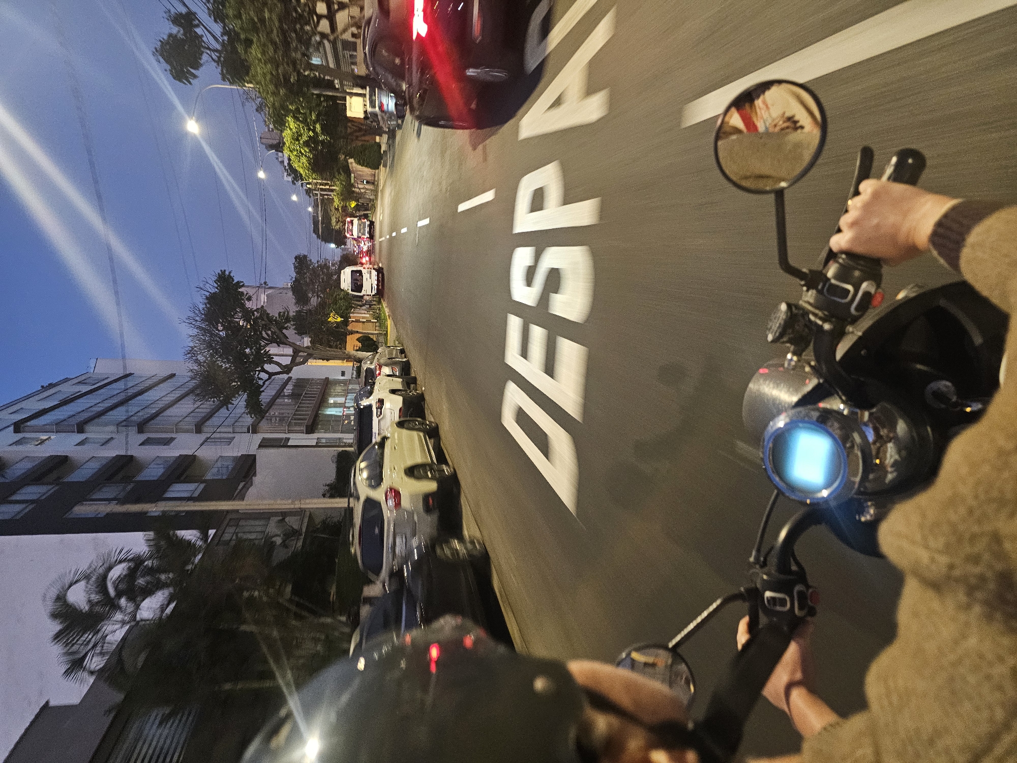 Motorcycle rider travels through Miraflores streets at night
