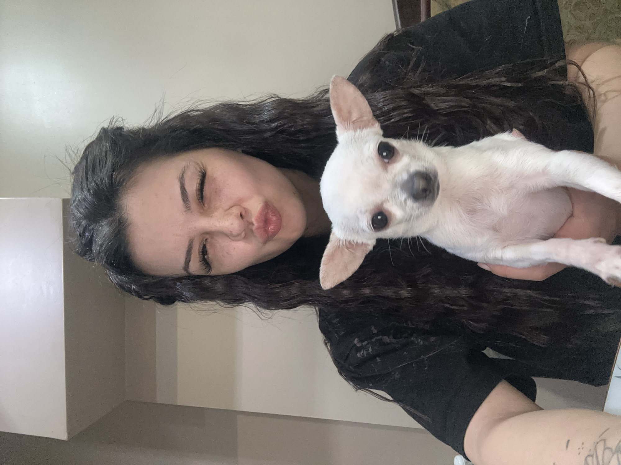 Woman takes selfies with small dog in Sliven apartment