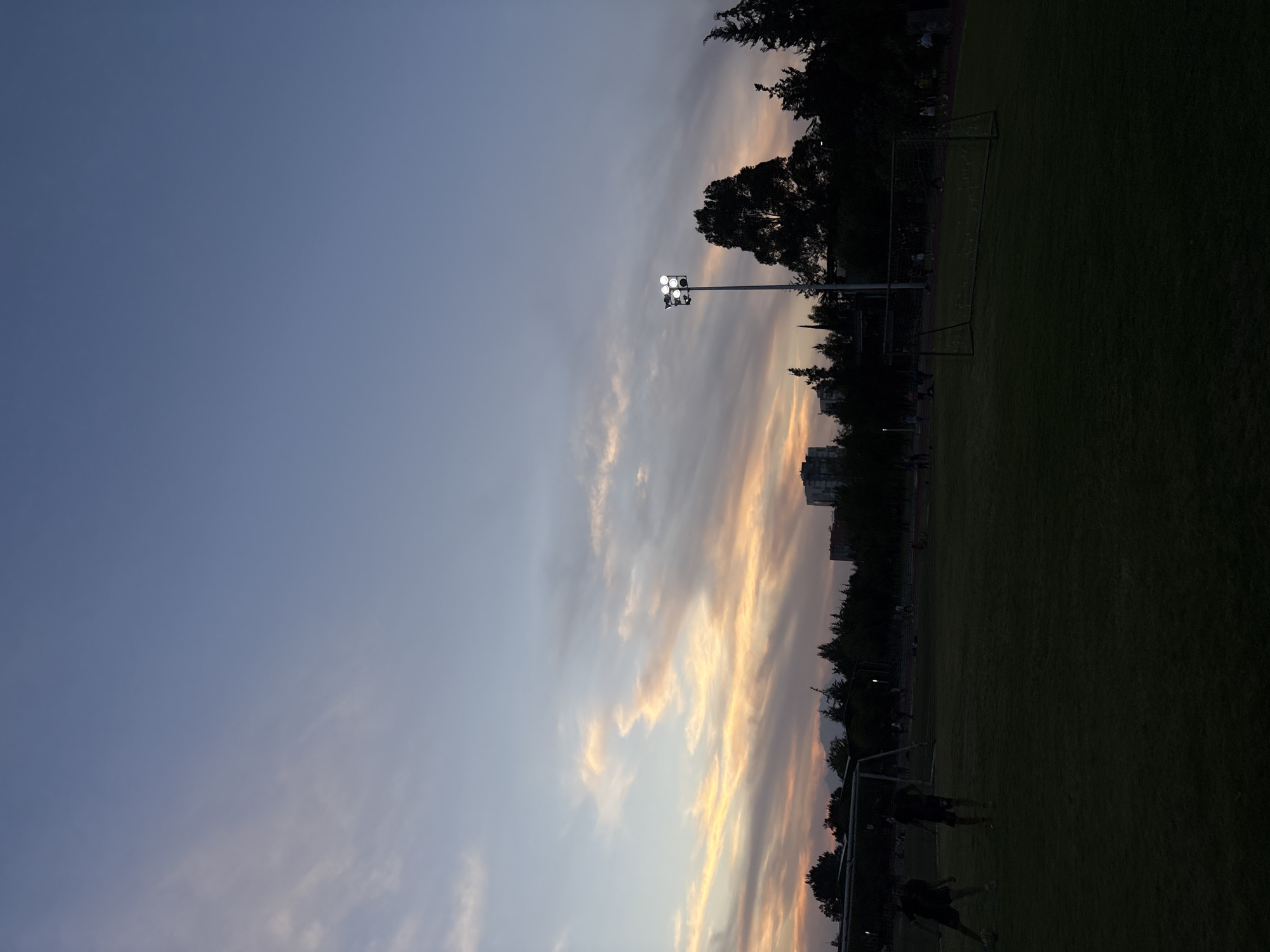 Late-night runner captured on athletic track in Puebla twilight