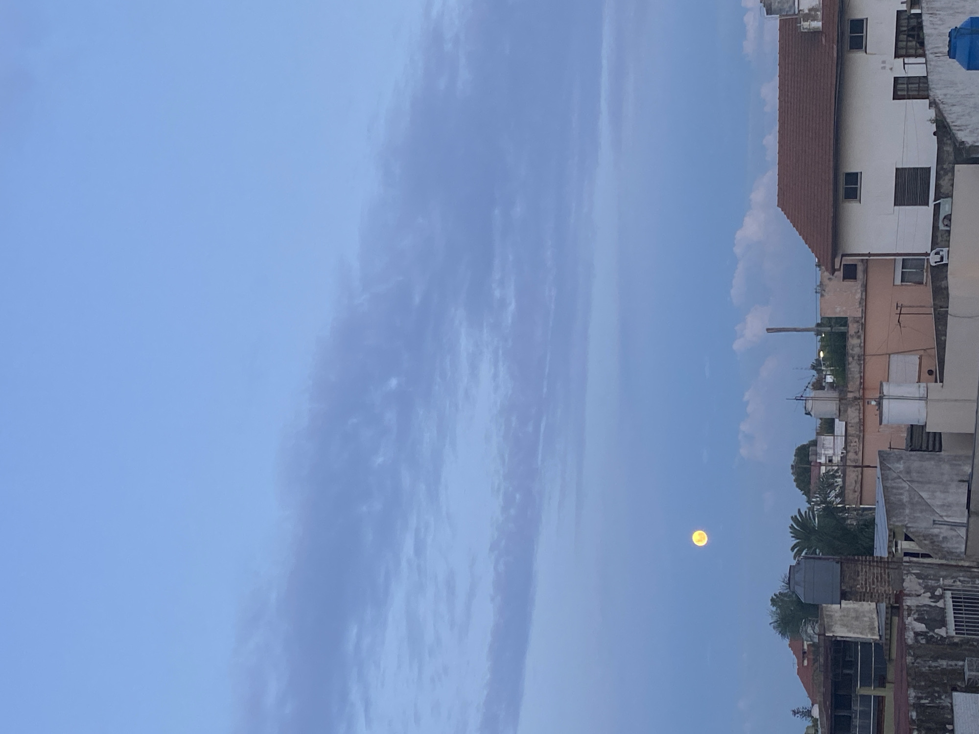 Full moon and striated clouds observed in Wilde, Argentina