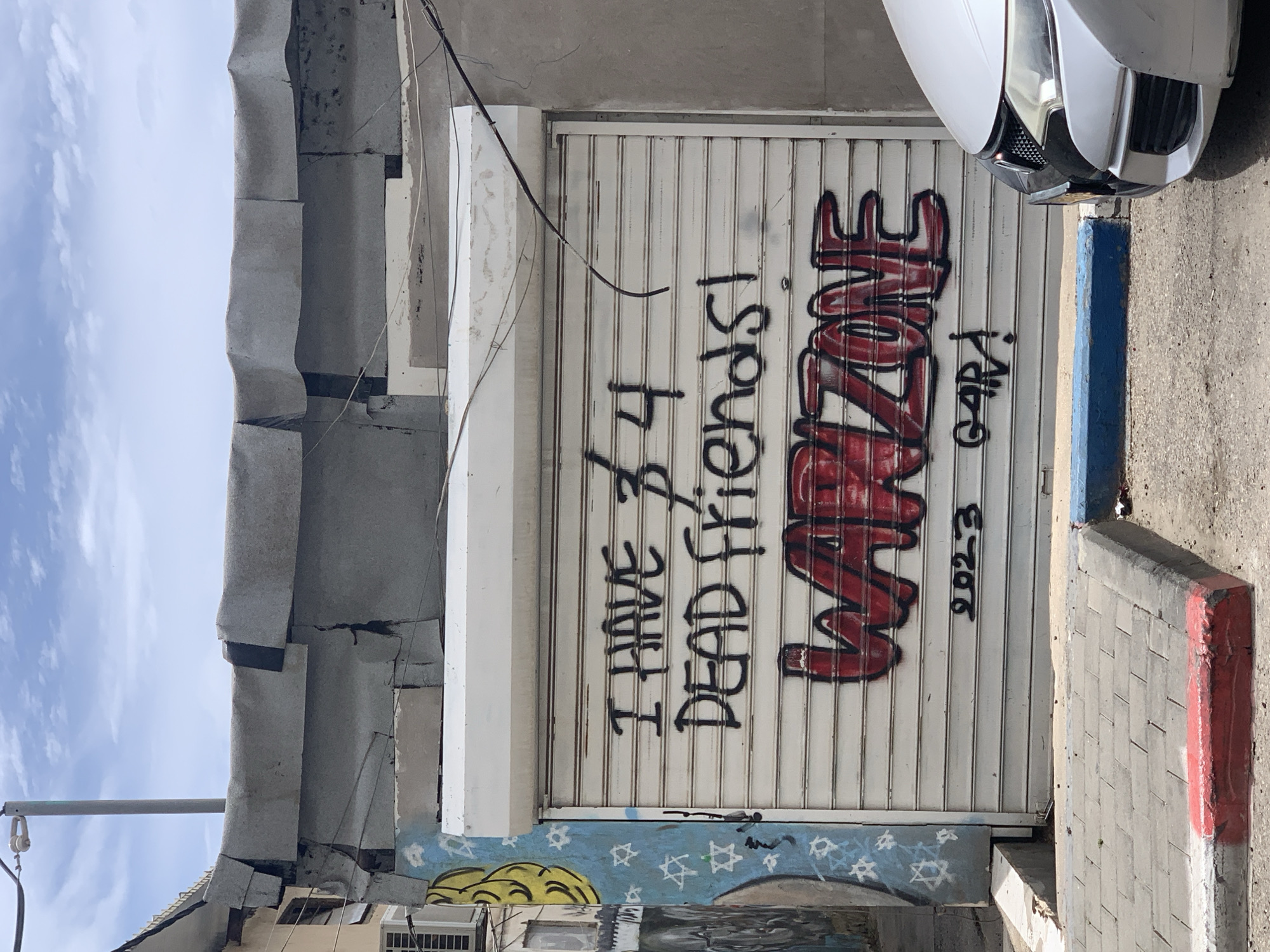 Graffiti about dead friends spotted on Tel Aviv security gate
