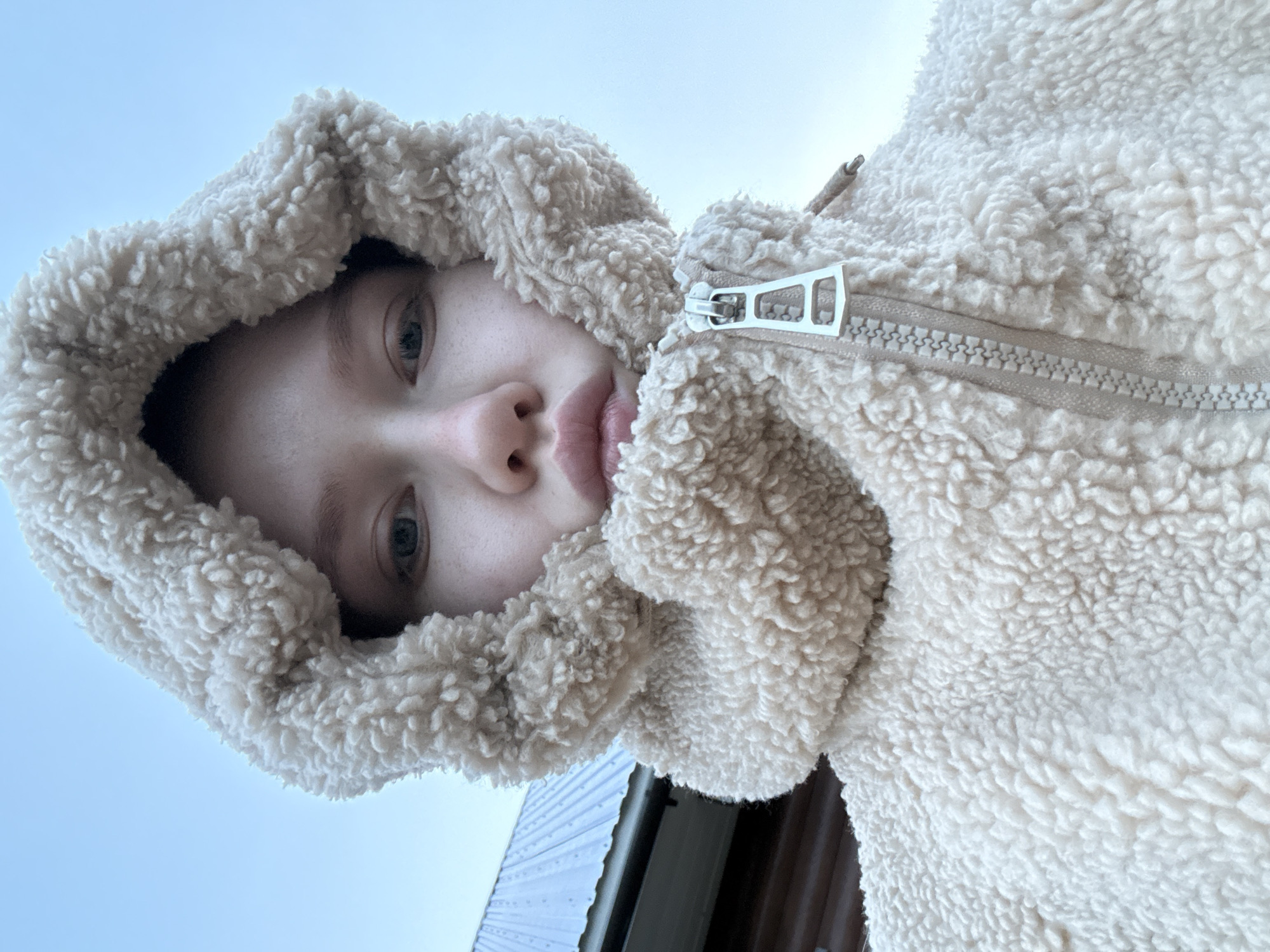 Young person in hooded jacket photographed in Zhigalki, Russia