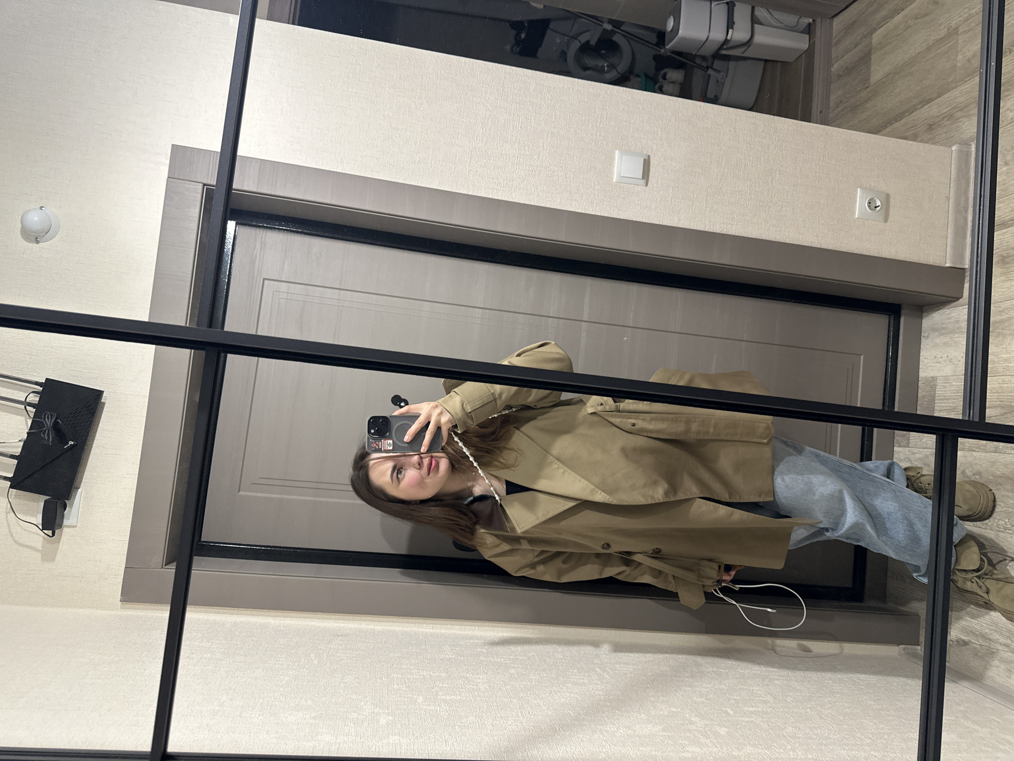 Woman takes mirror selfie in Perm hallway