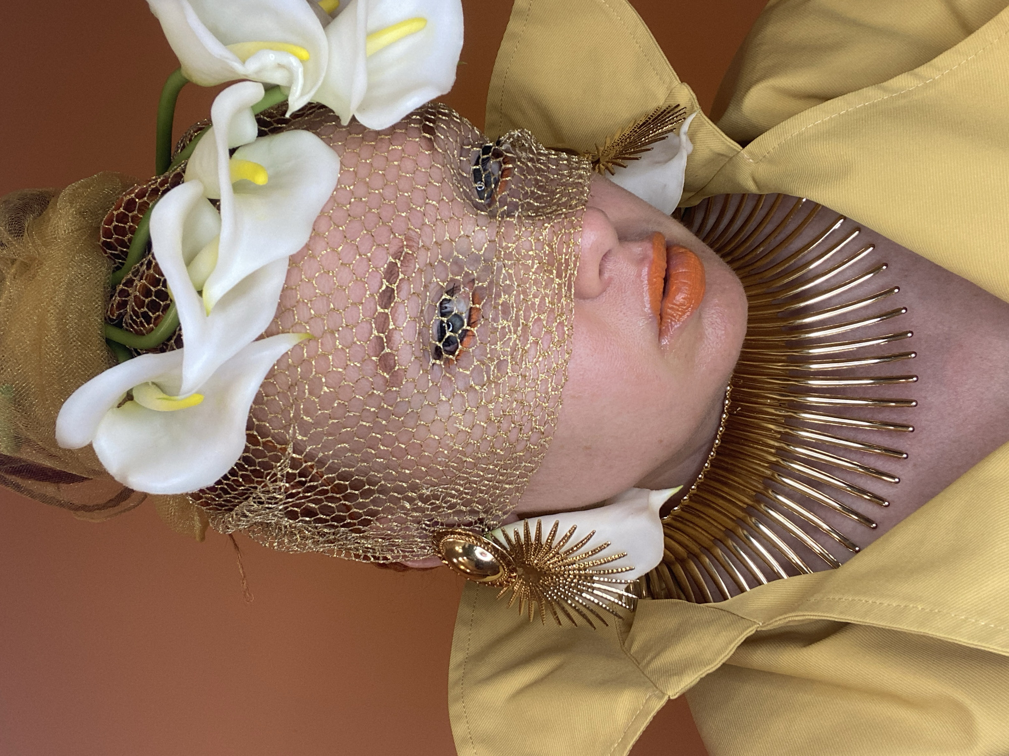 Avant-garde fashion shoot featuring gold veils and calla lilies