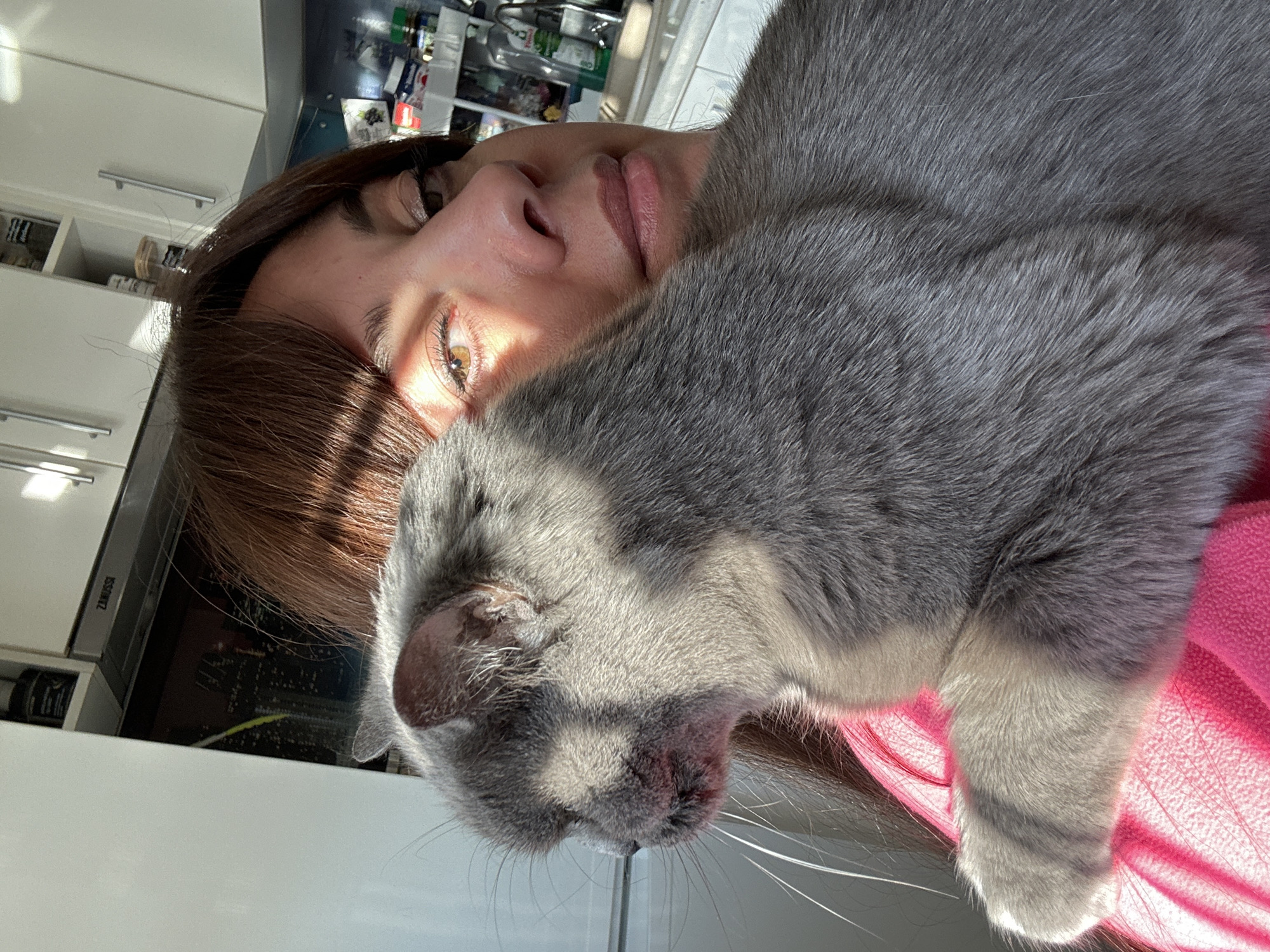 Woman takes selfies with gray cat in Riga apartment