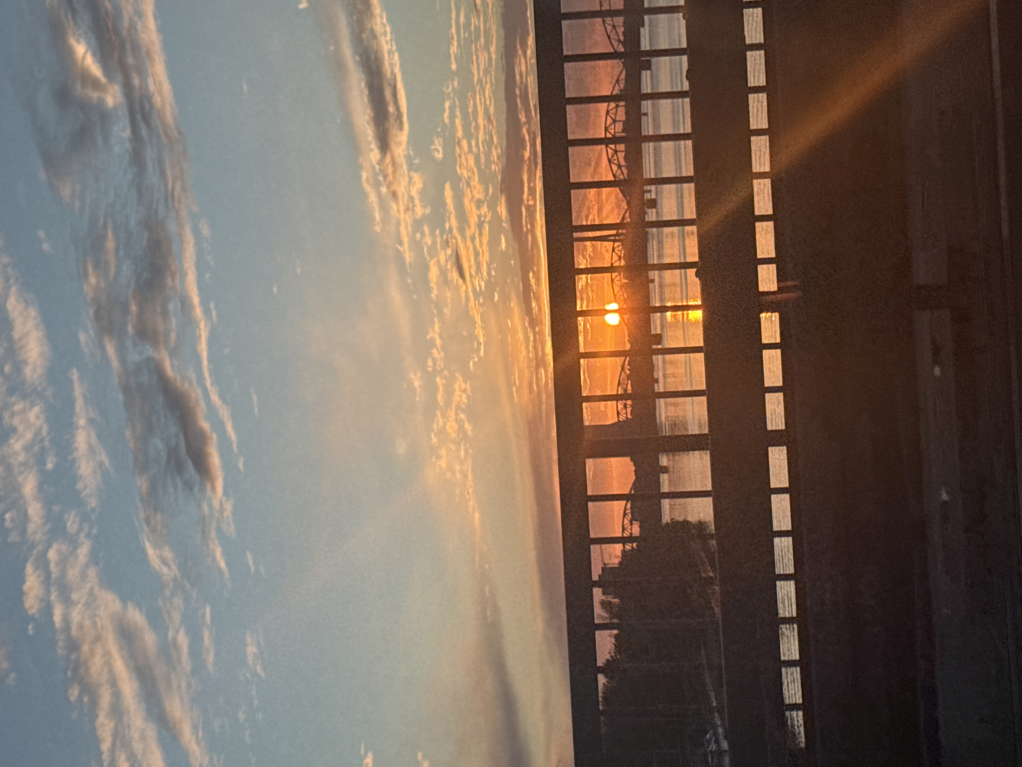 Gridded window frames a vivid sunset over Riga