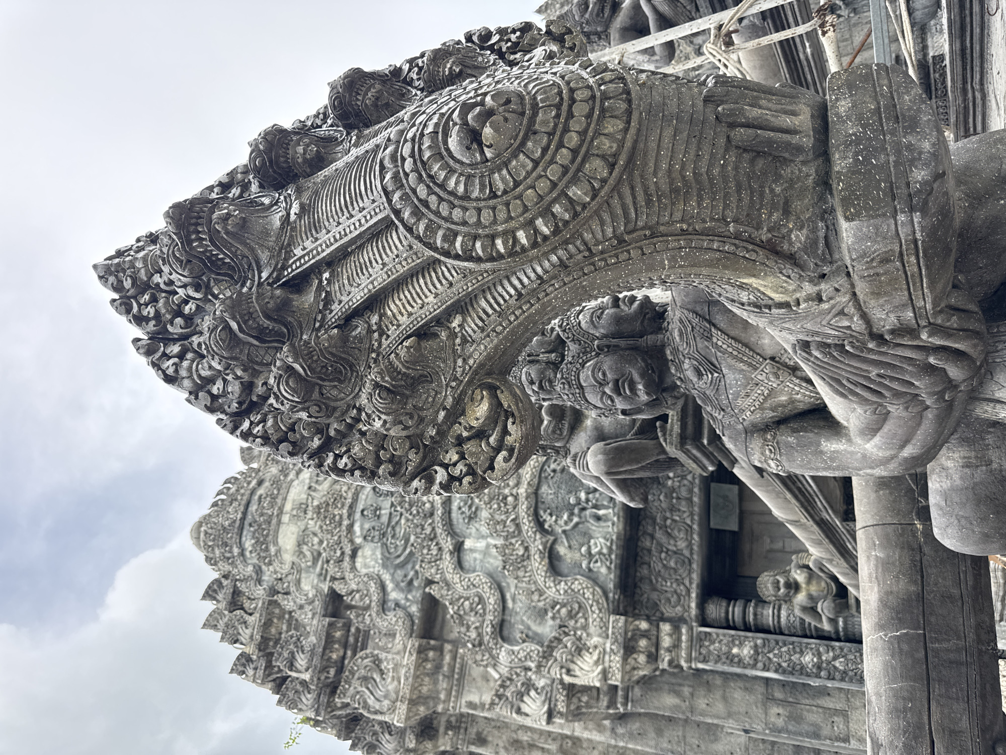 Detailed stone carvings and mythological statues at a Thai temple