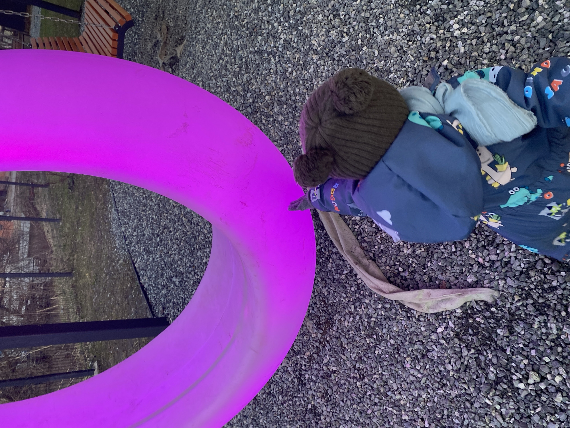 Child plays with colorful rings in Izhevsk outdoor area