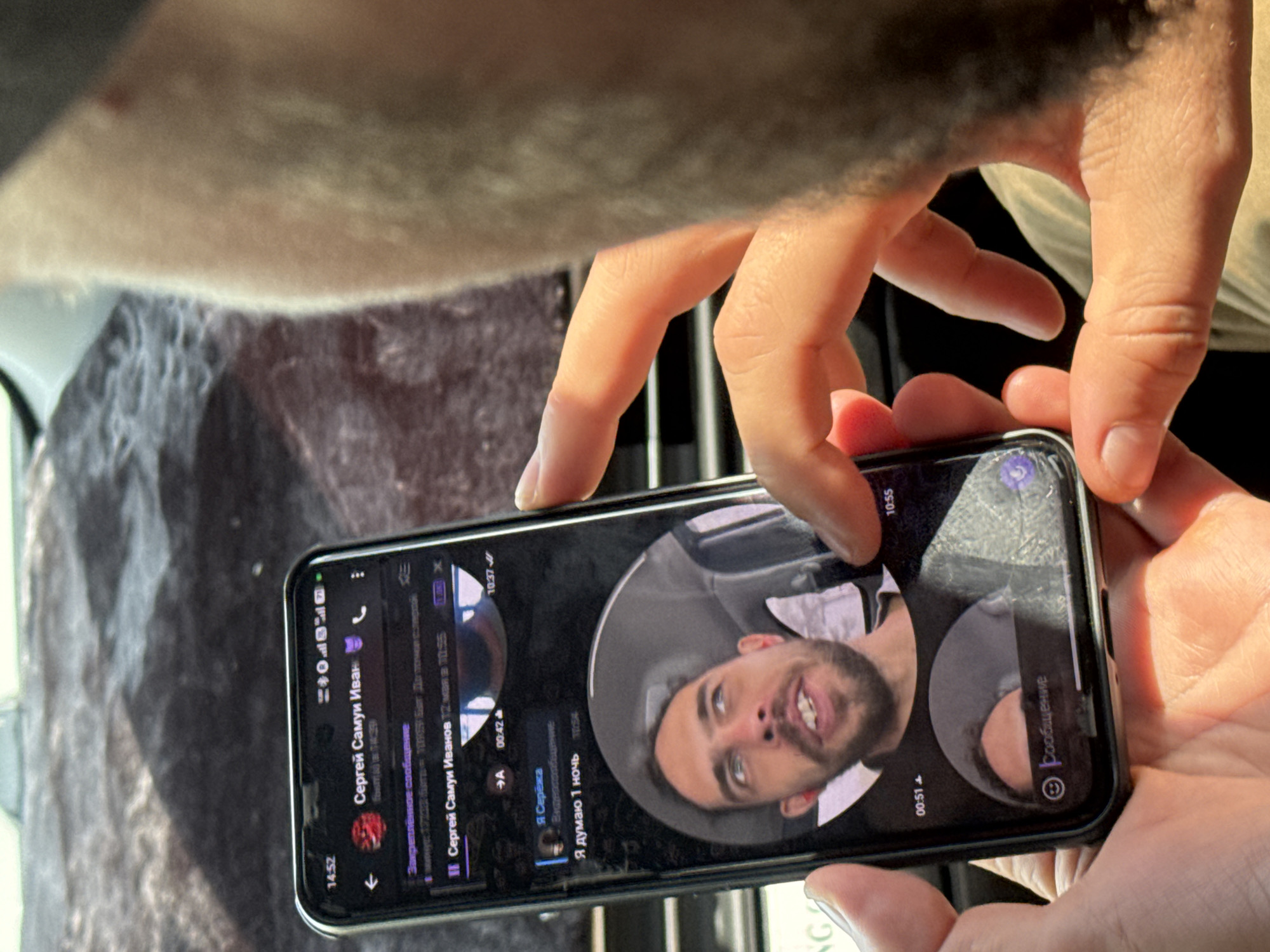 Person uses smartphone for calls, messaging in Hanoi vehicle