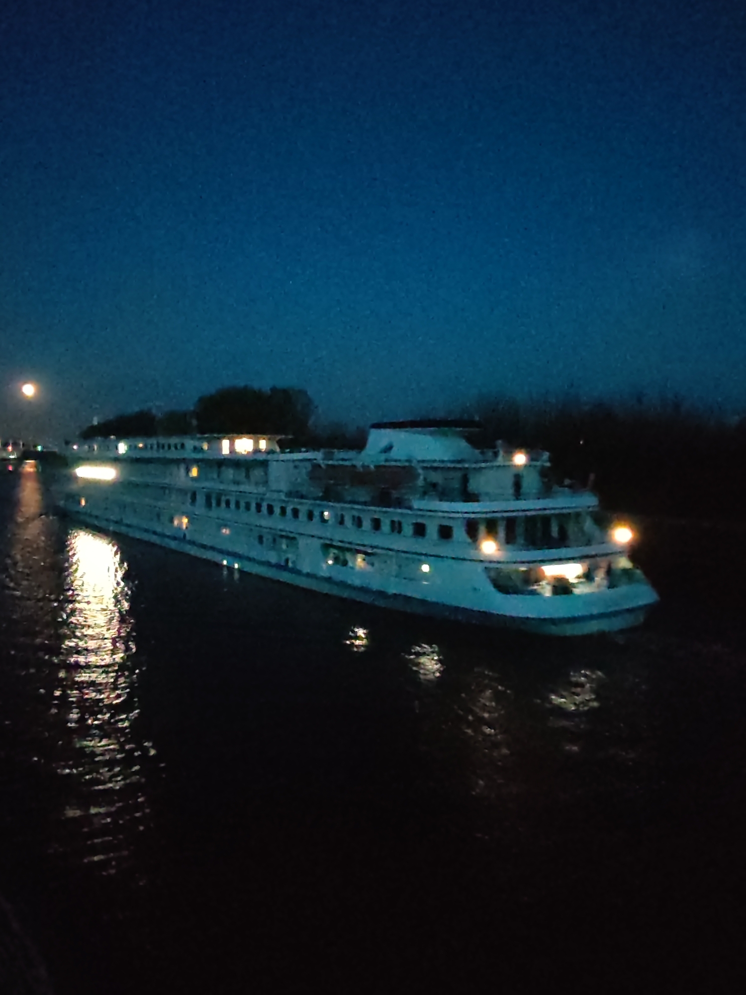 Cruise ship travels dark river near Dmitrov at night