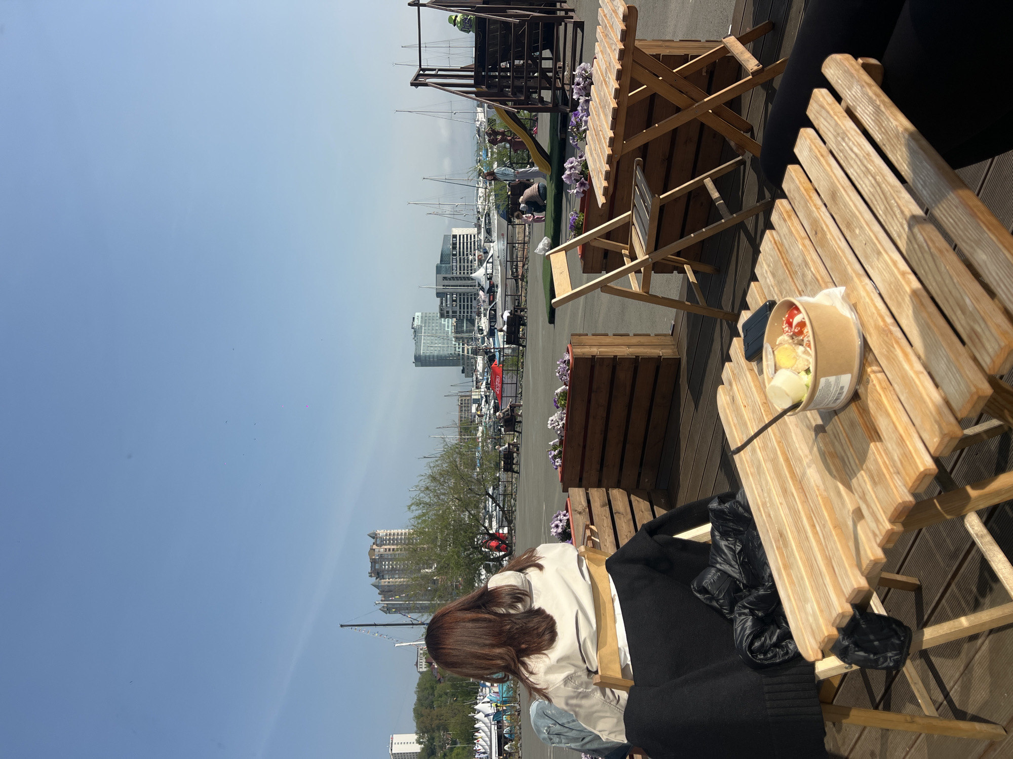 Woman takes morning selfies at Vladivostok marina with takeout