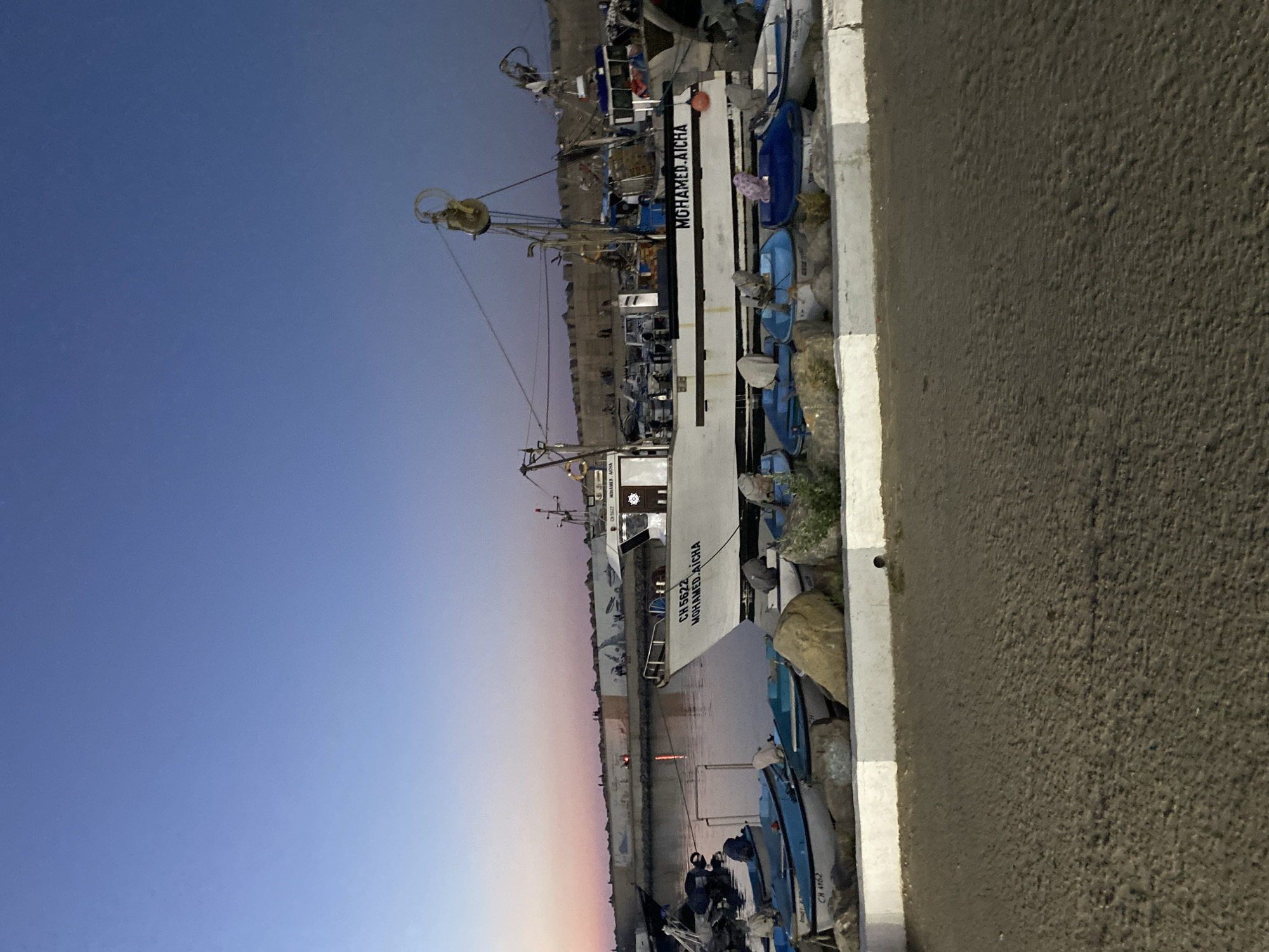 Fishing boats moored at dusk in Tipaza harbor