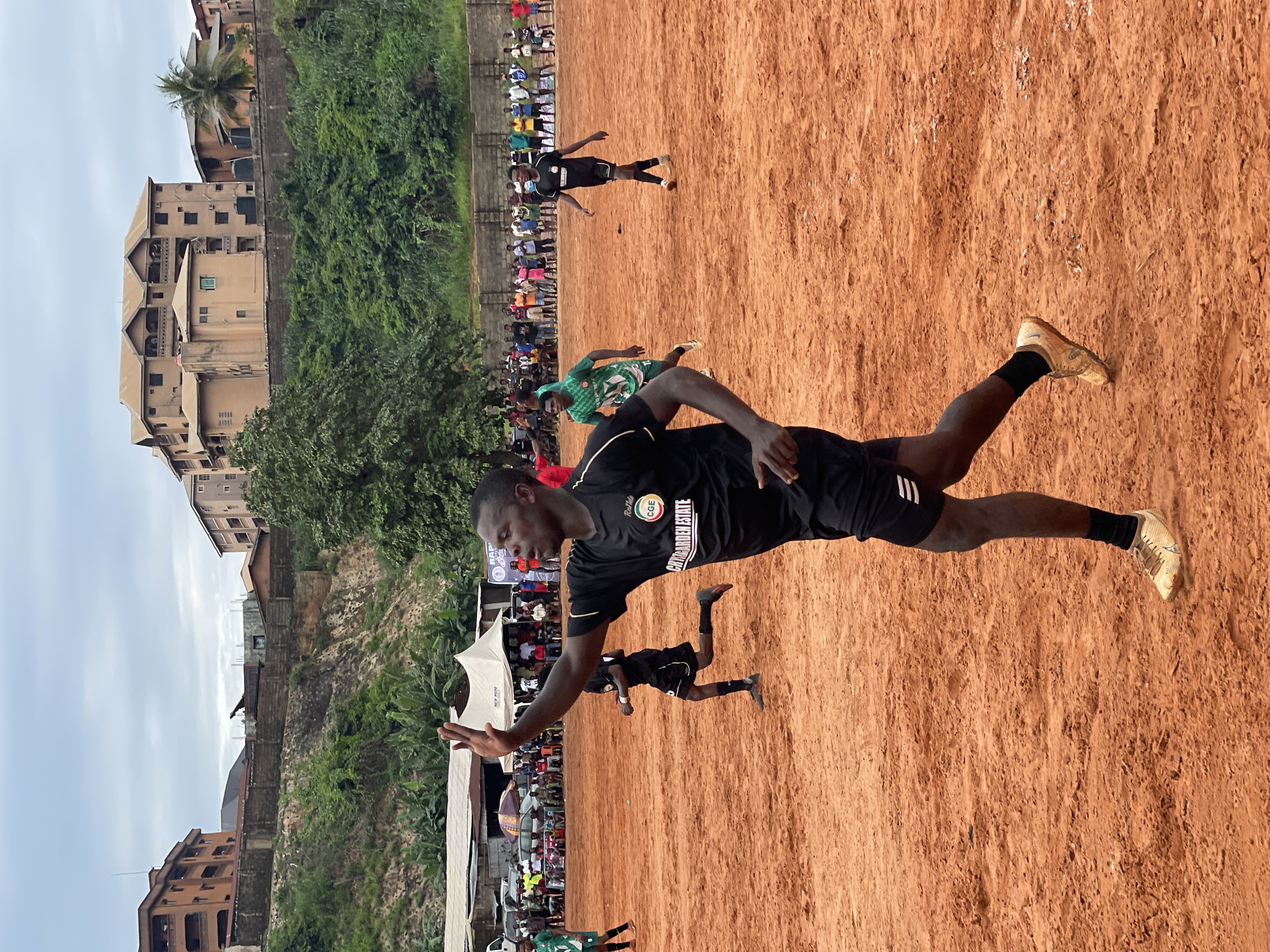 Amateur soccer match played on dirt field draws spectators