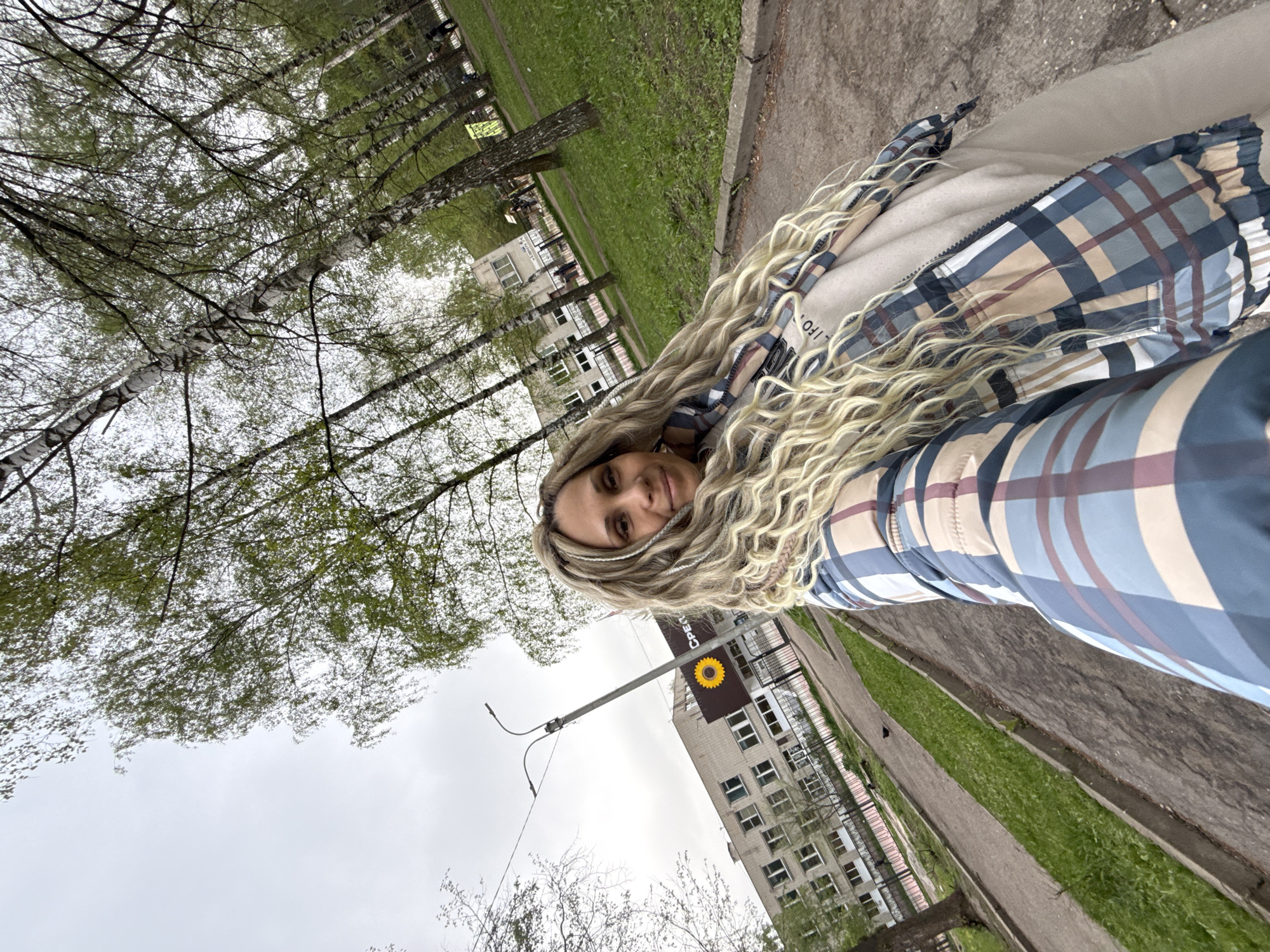Woman with curled blond hair photographed from below angle