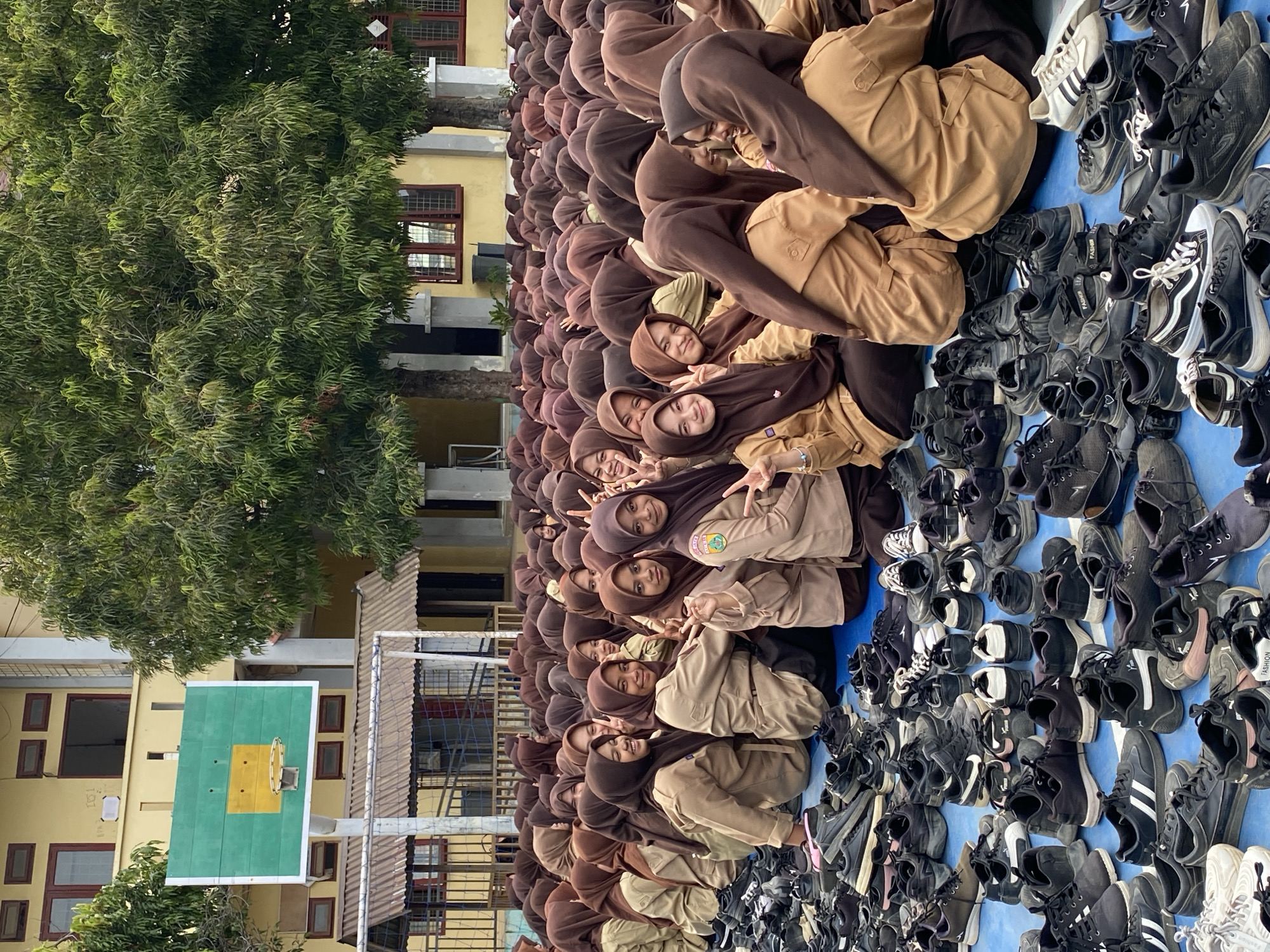 School assembly on a blue court, students in uniform