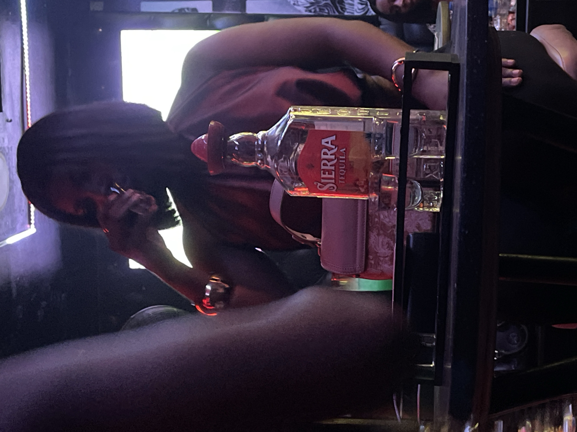Bar patron takes phone call over tequila in Nigeria