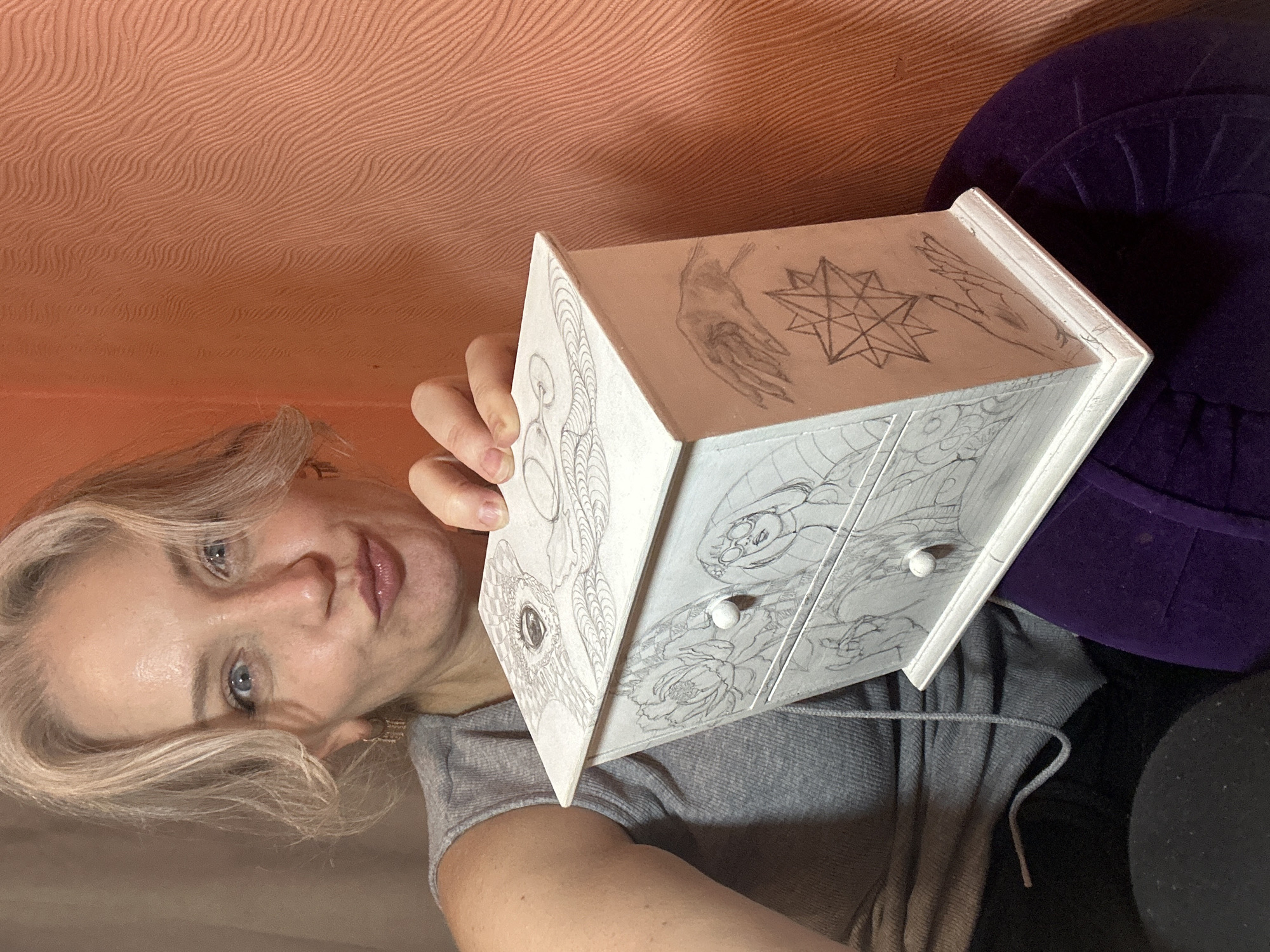 Hand-drawn pencil art decorates a wooden jewelry box in Kyiv