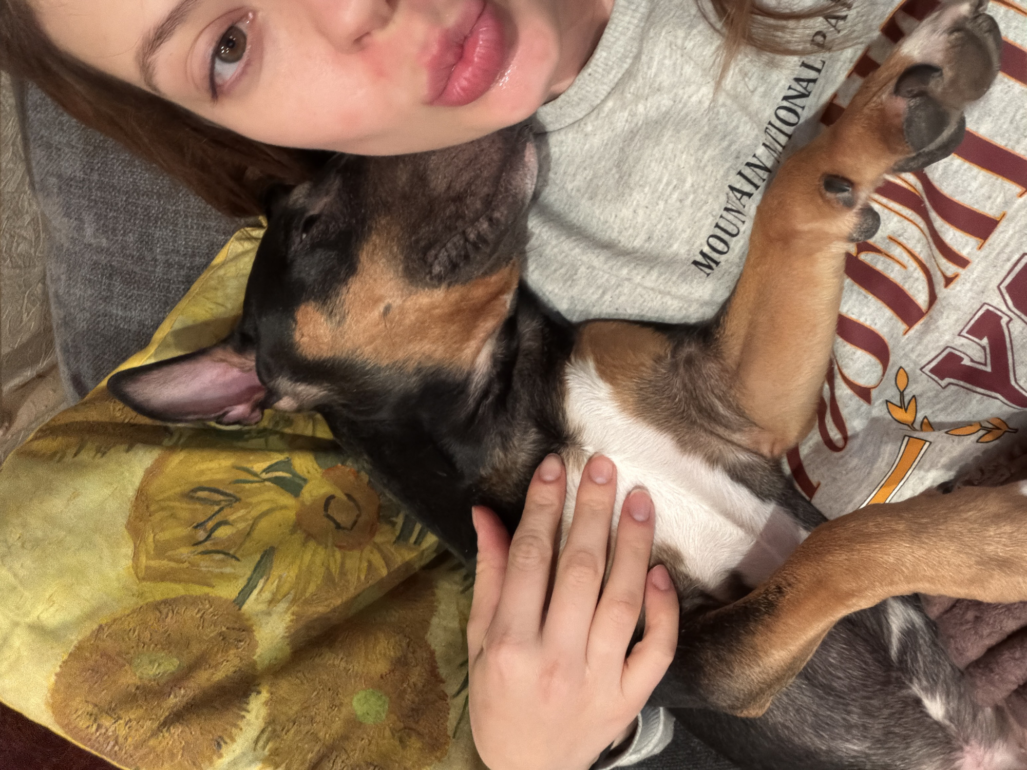 Woman cuddles tri-colored puppy in Khimki, Russia