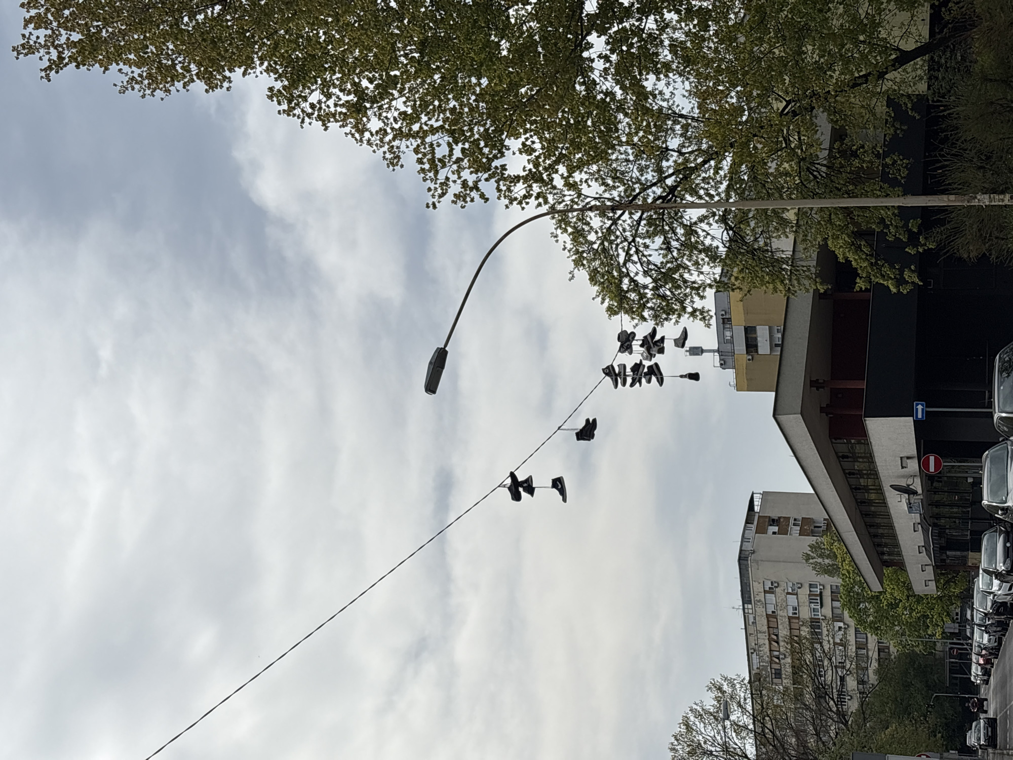 Witness documents everyday Belgrade street scenes, hanging shoes, shopping center