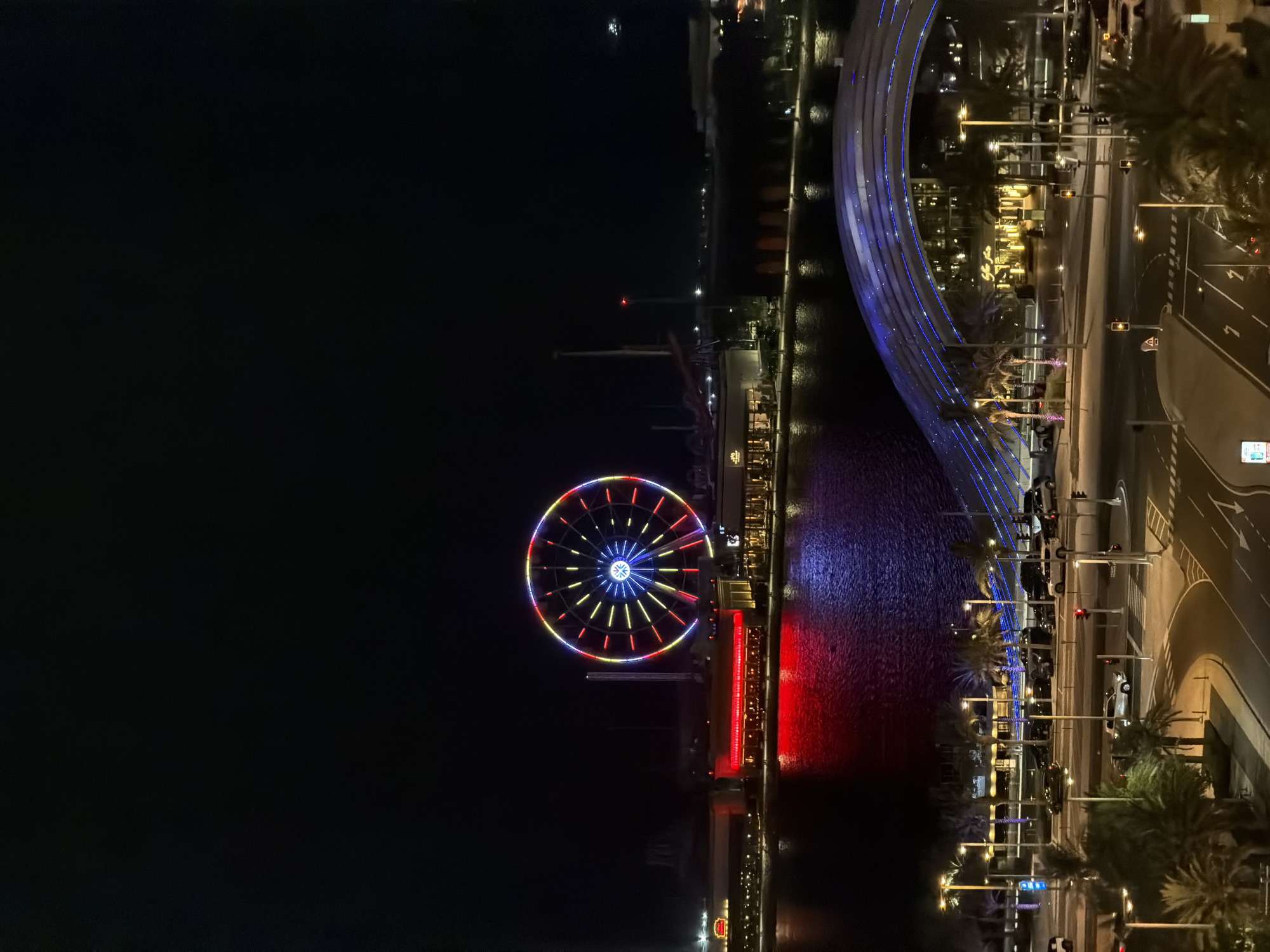 Evening cityscape observations document illuminated Lusail waterfront and Ferris wheel
