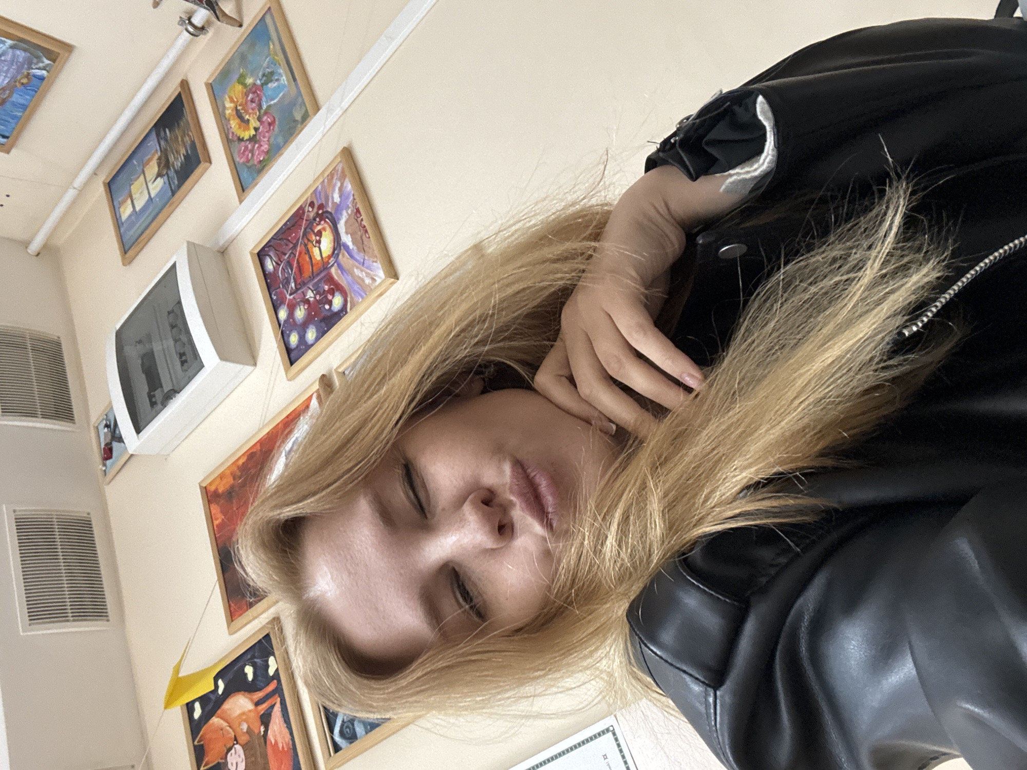 Woman takes selfies indoors in Podosenikha, Russia