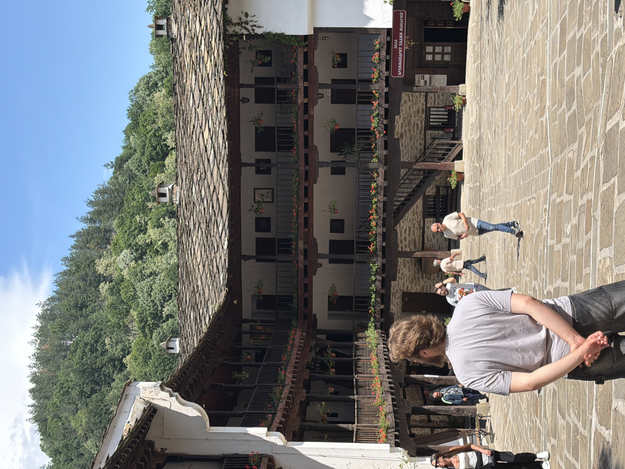 Visitor documents historic Troyan Monastery architecture in Bulgaria