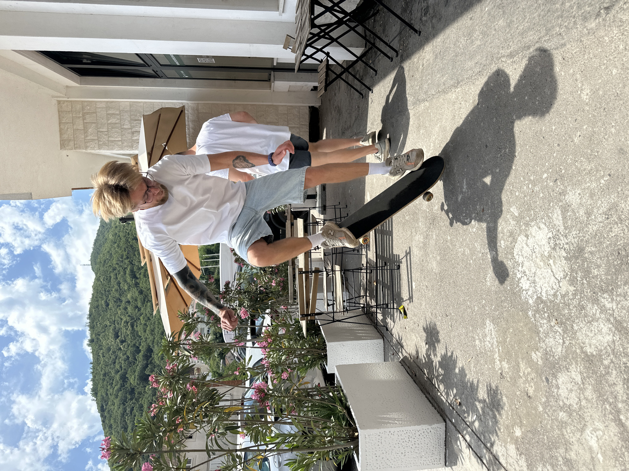 Skateboarding and dog watching city life captured in Budva