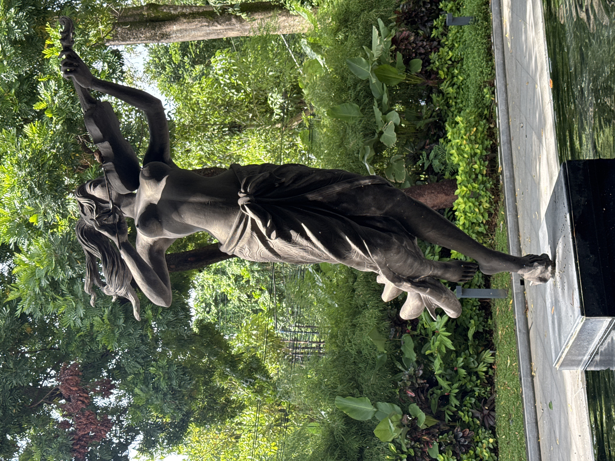 Tourist captures statues and tropical scenery in Kuta Selatan