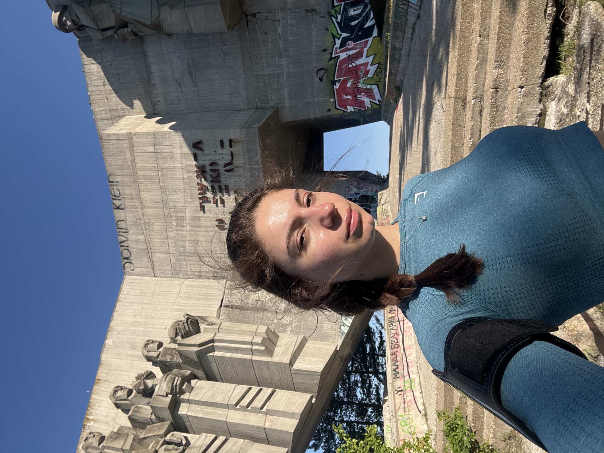 Tourists take playful photos at Buzludzha Monument in Varna