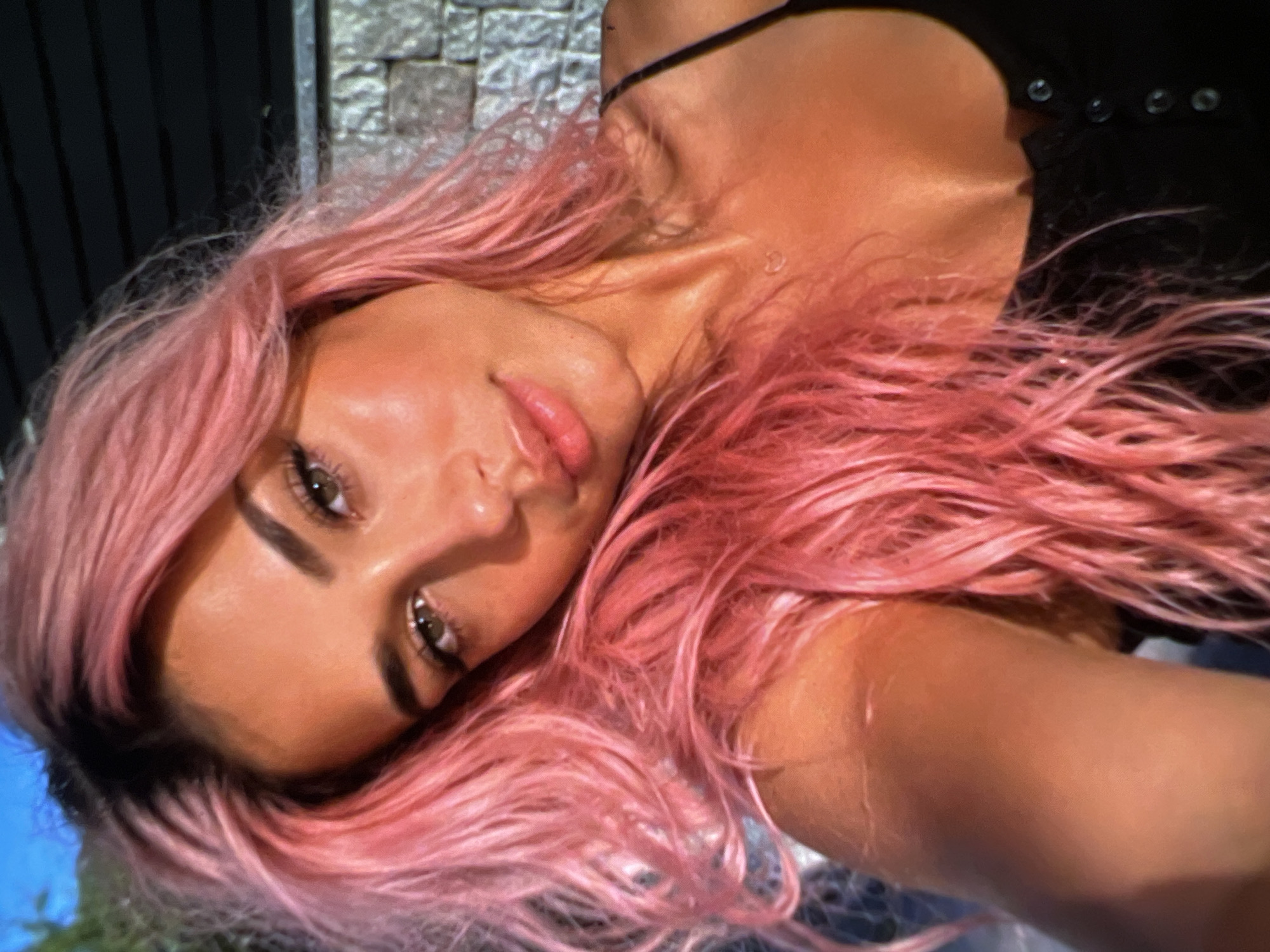 Pink hair, black fits, and a Guess bag selfie session