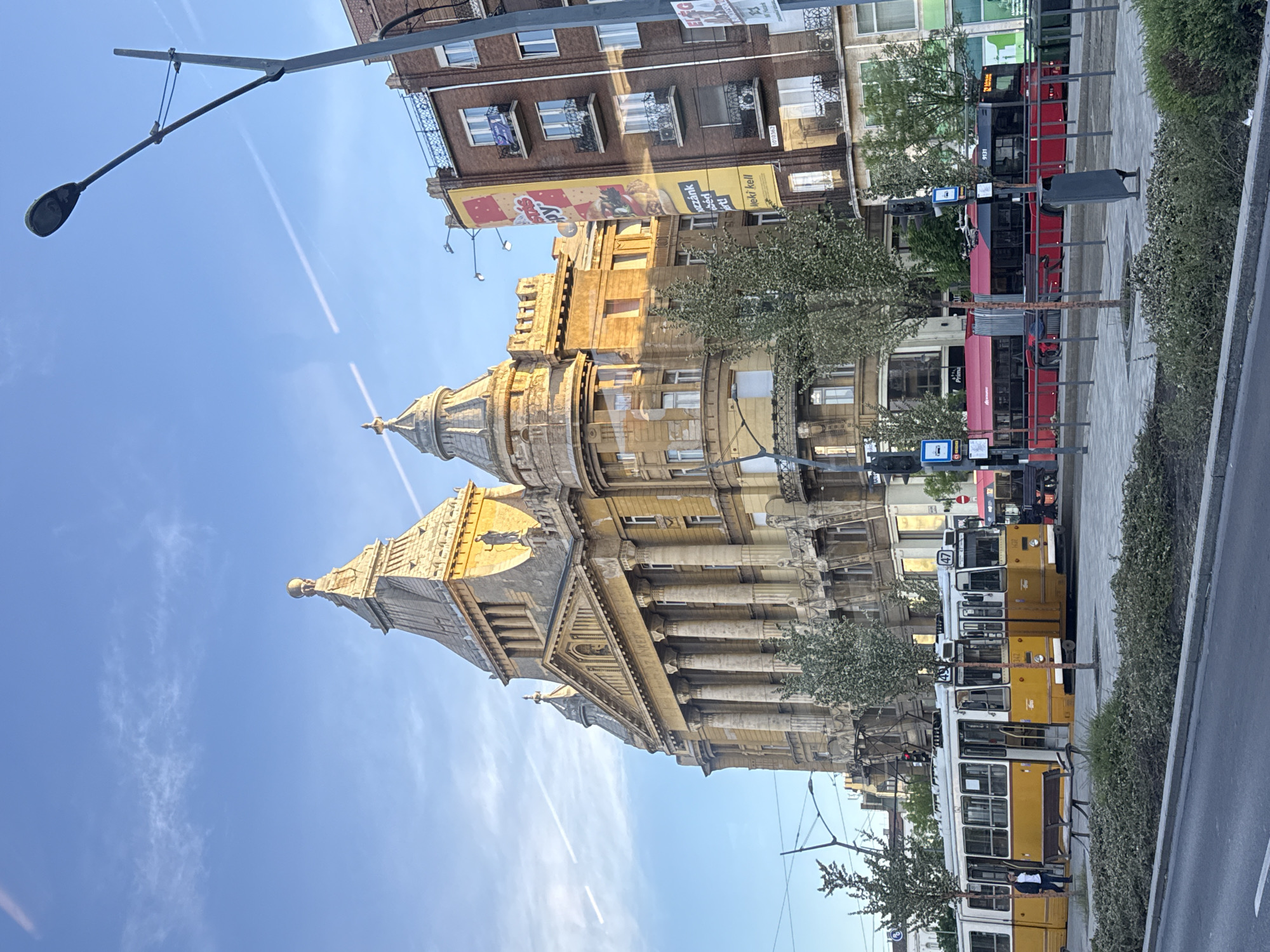Historic yellow tram operates alongside traffic in Budapest streets
