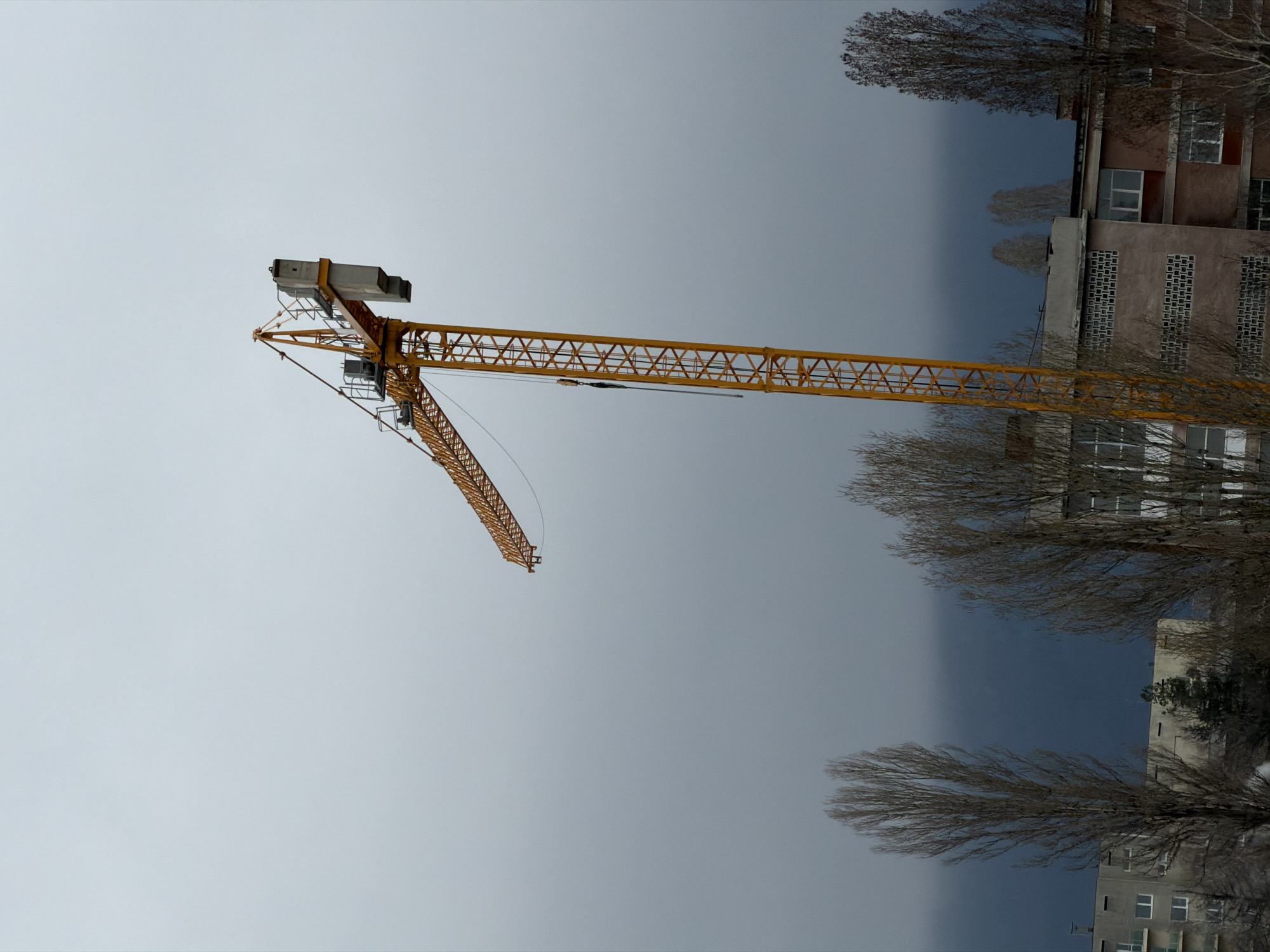 Construction crane spotted in Sofia cityscape under cloudy skies