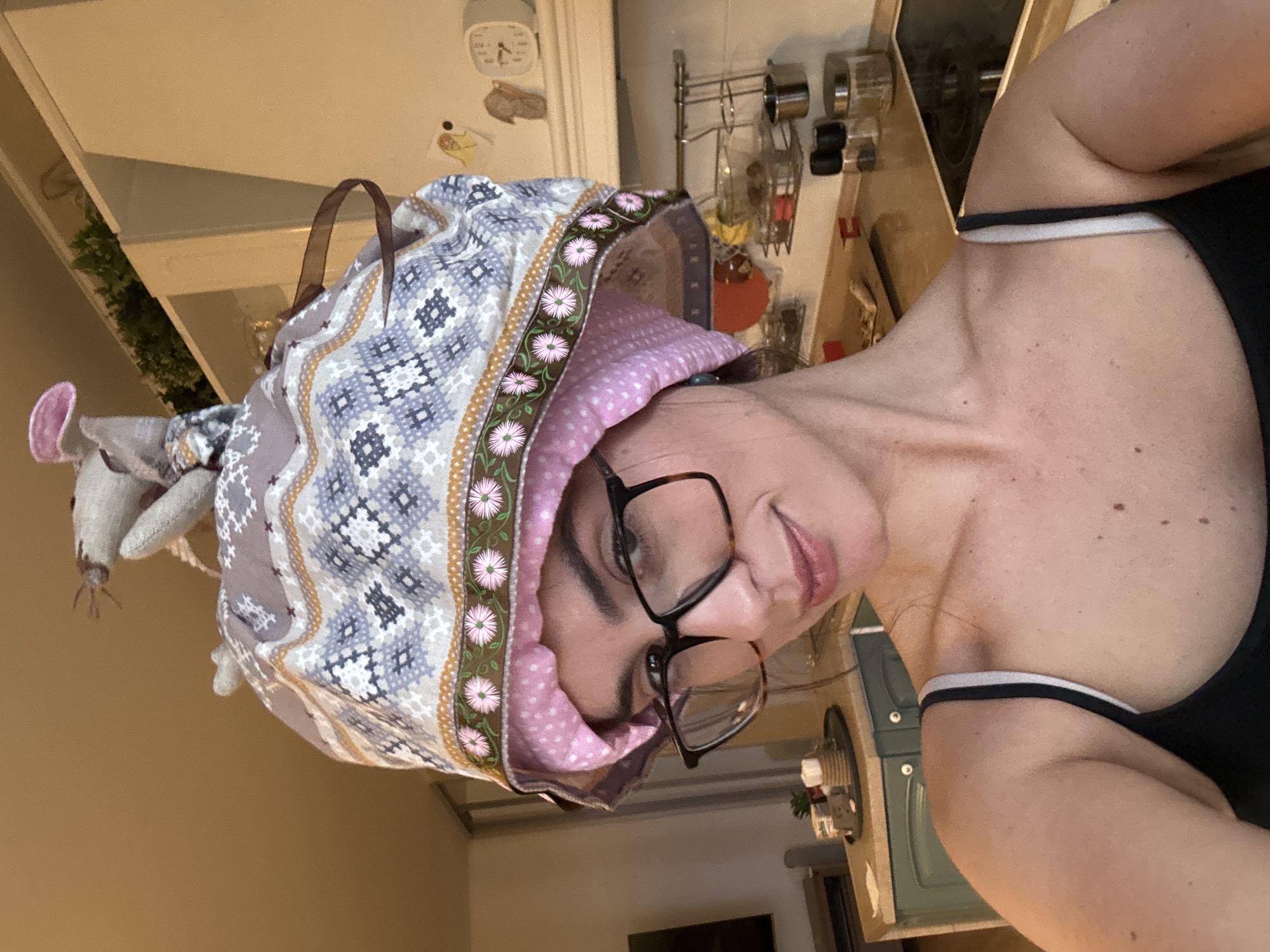 Woman and cloth mouse doll spotted in kitchen setting
