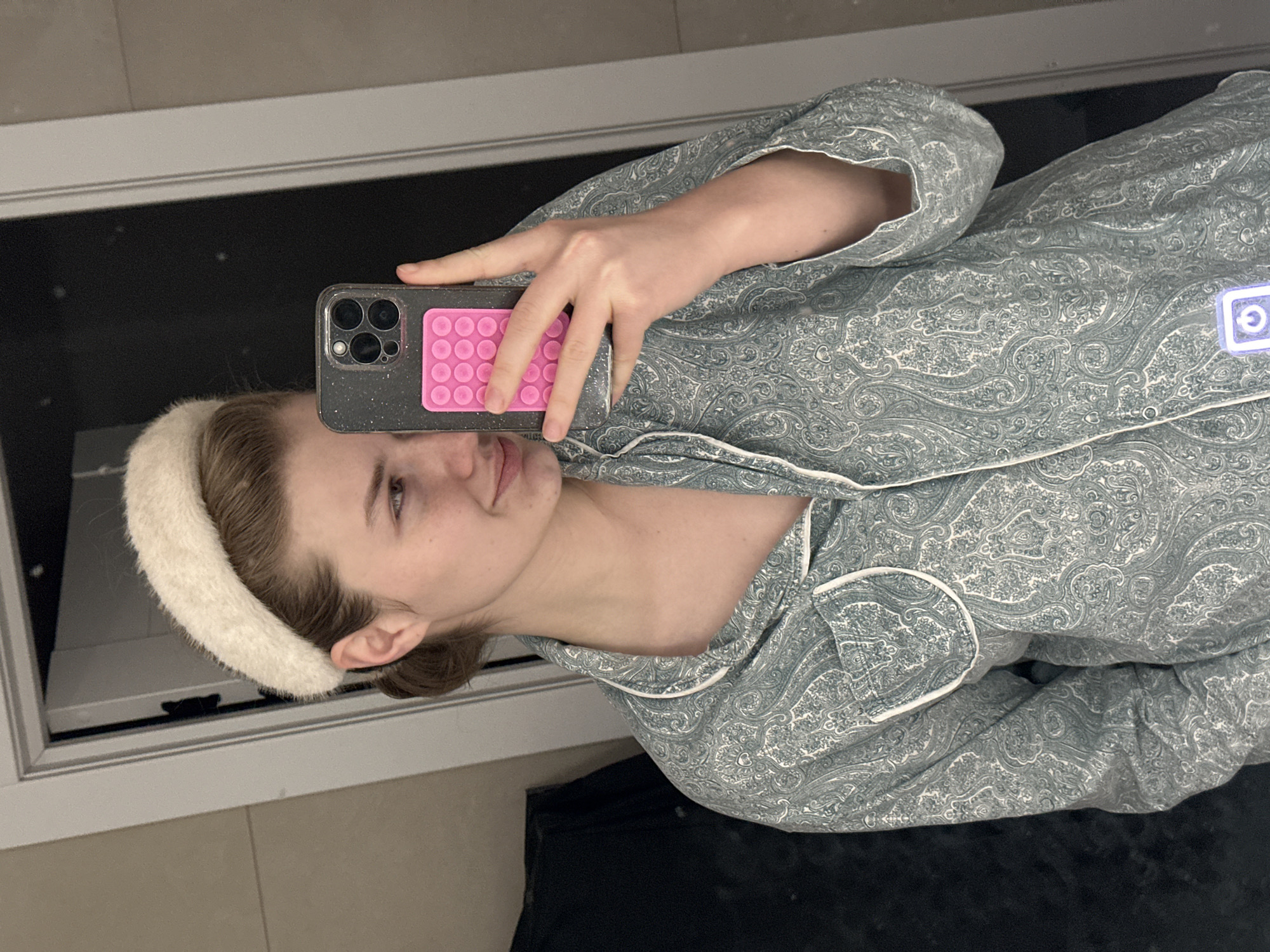 Woman takes mirror selfie in pajamas in Kazan