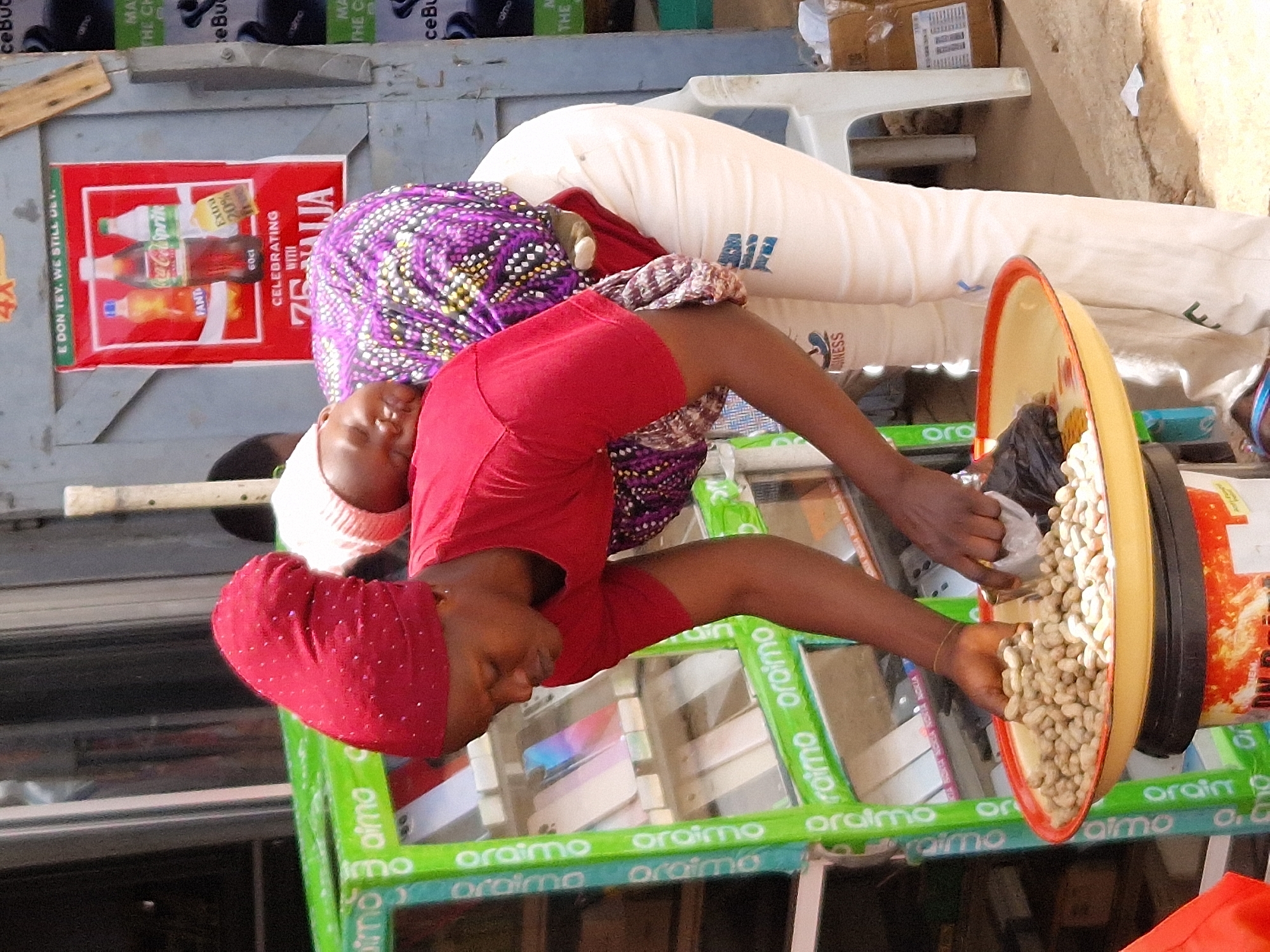 Street vendors and armed personnel in a busy African market setting