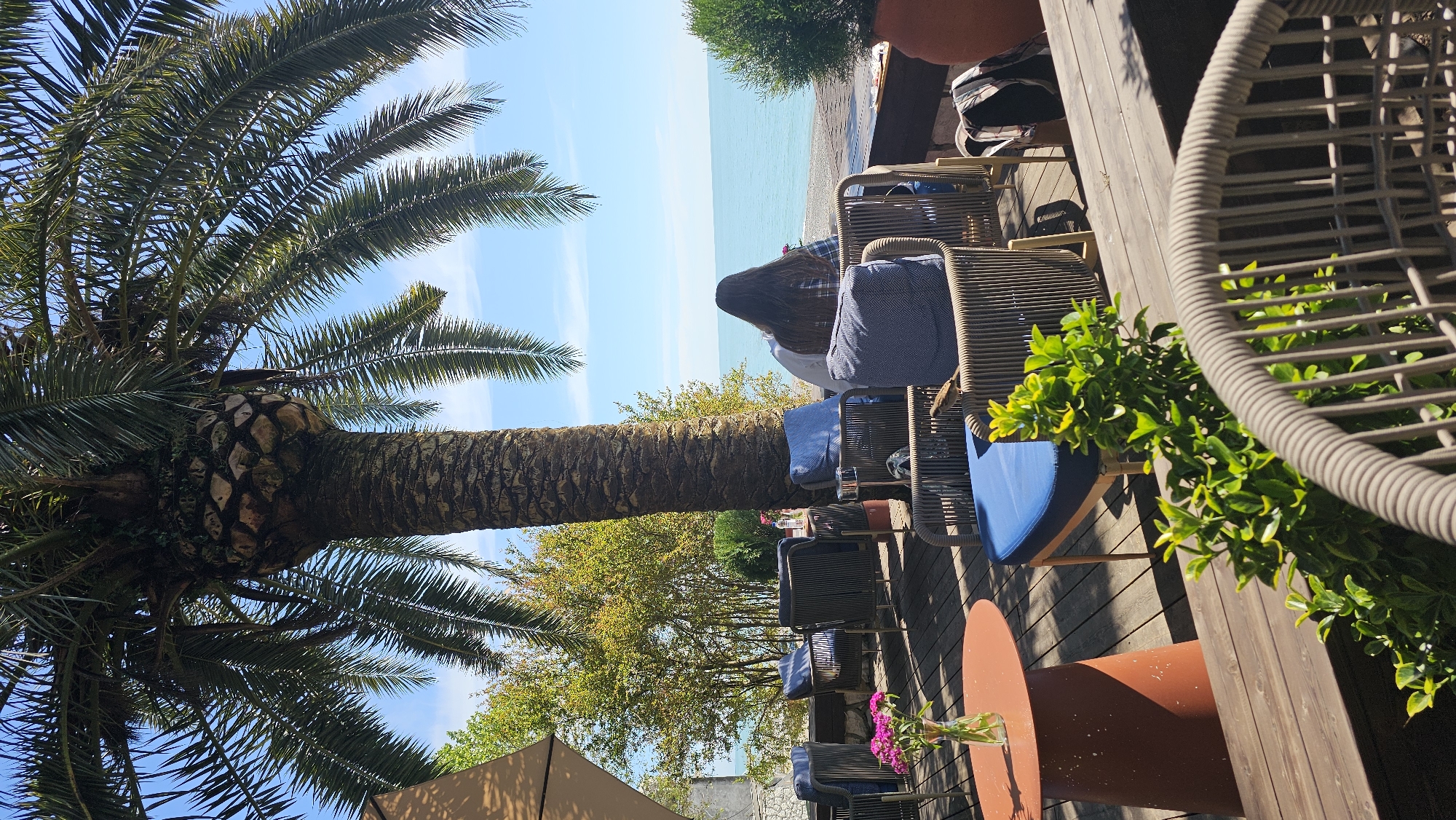 Woman enjoys coffee and cake at Gagra beachside cafe