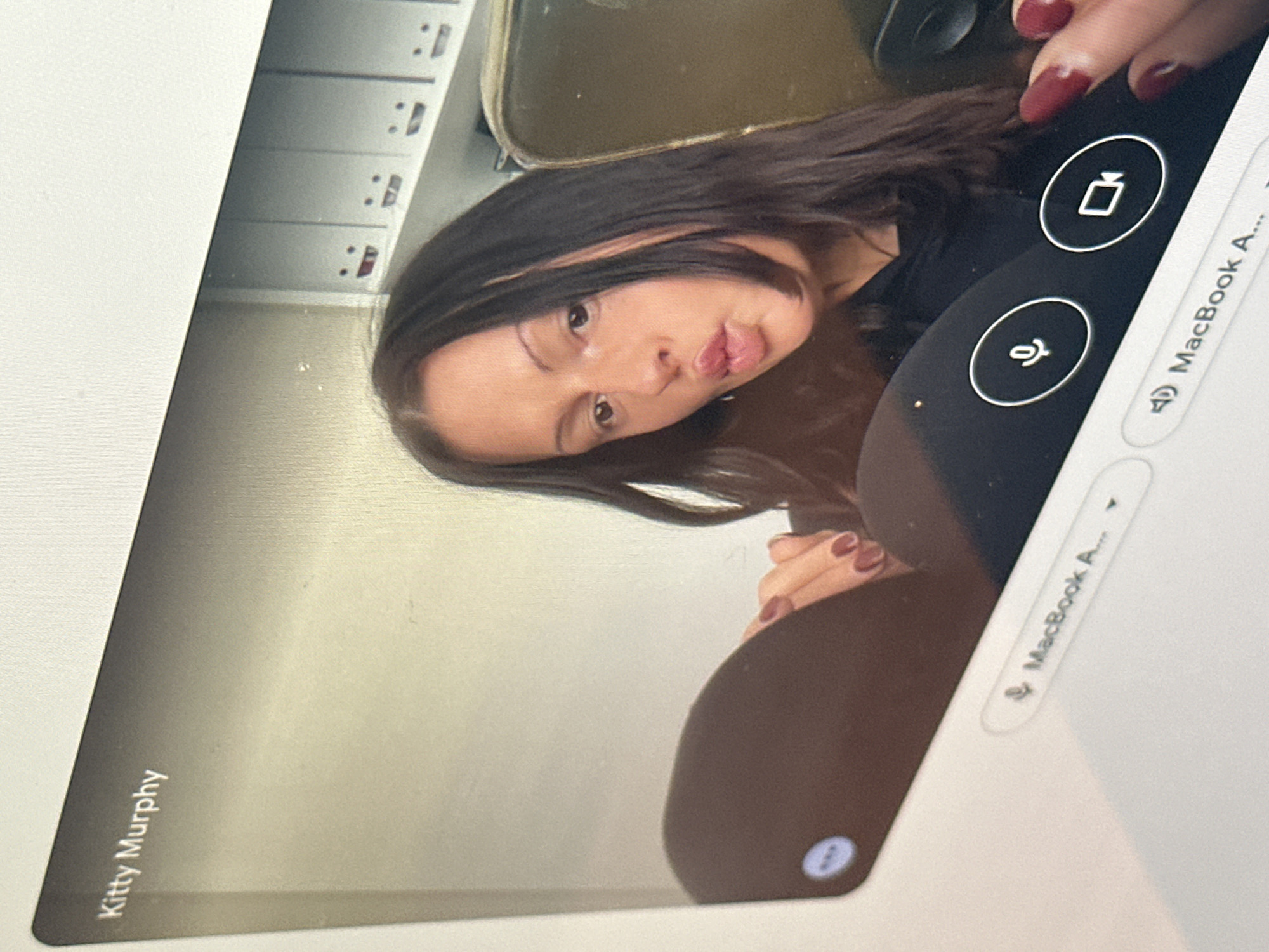 Video call participant captured on laptop screen in Kent