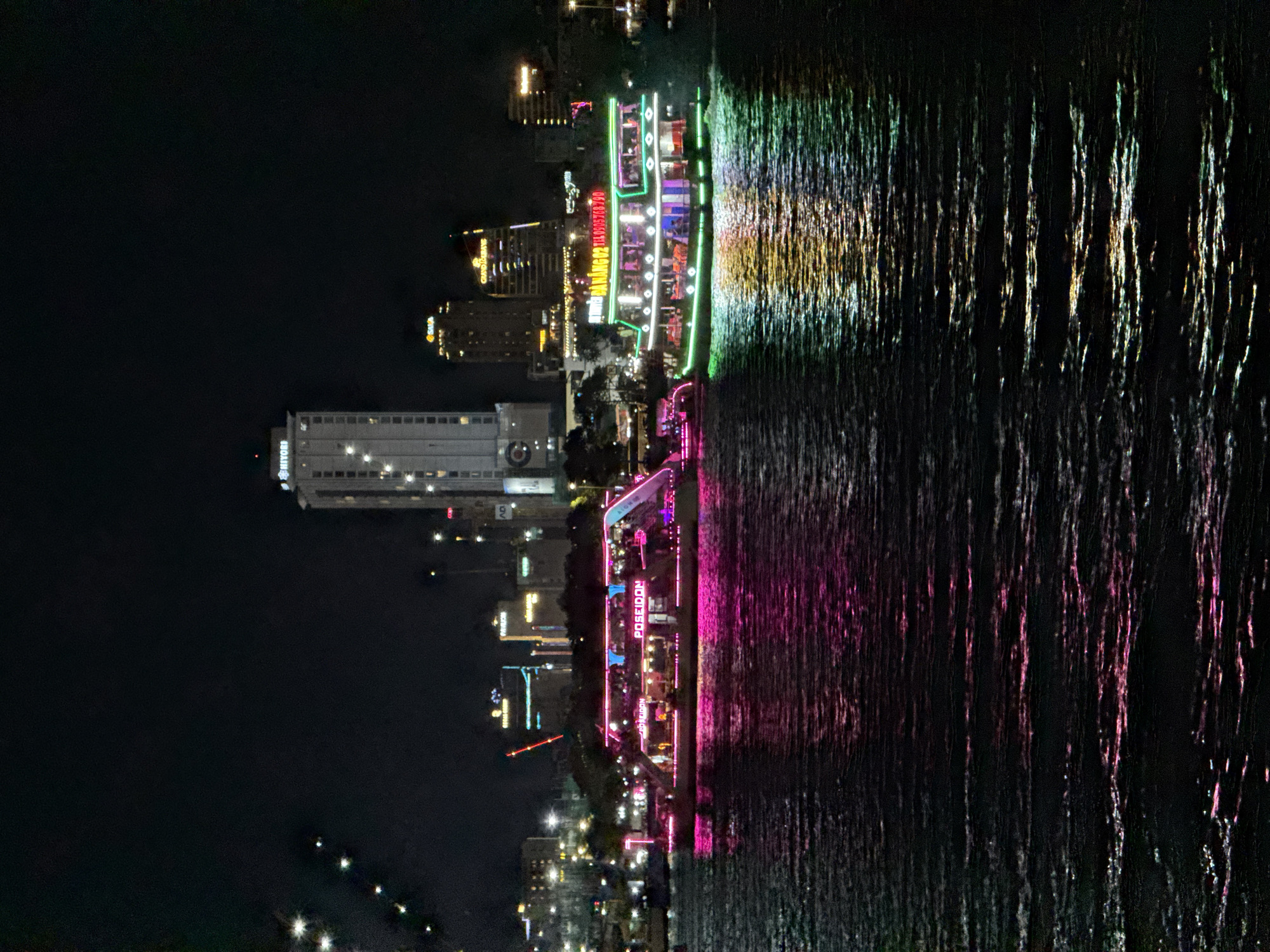 Illuminated tour boats cruise Han River in nighttime Đà Nẵng