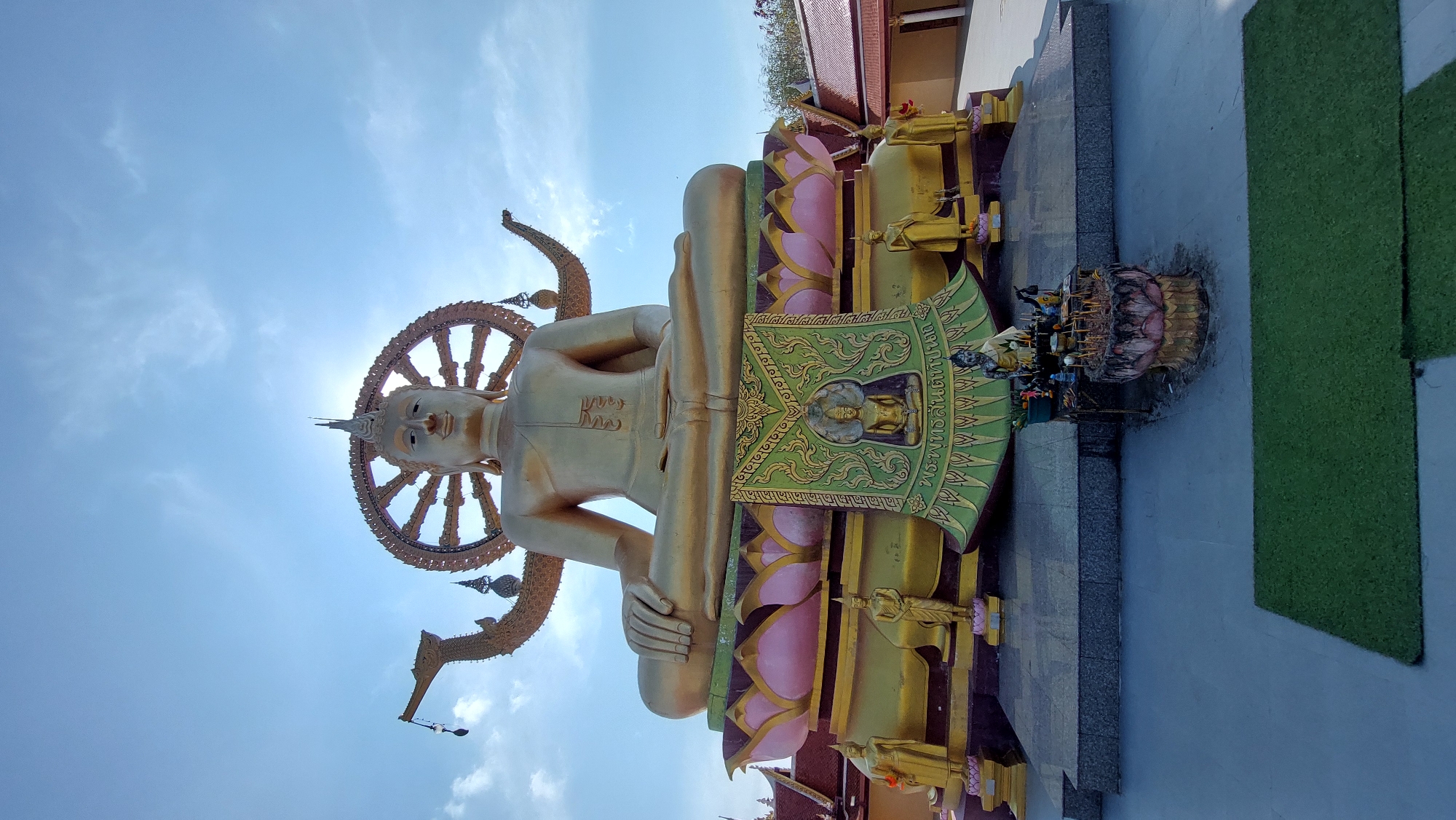 Temple visitor documents Buddhist statues at Baan Plai Laem