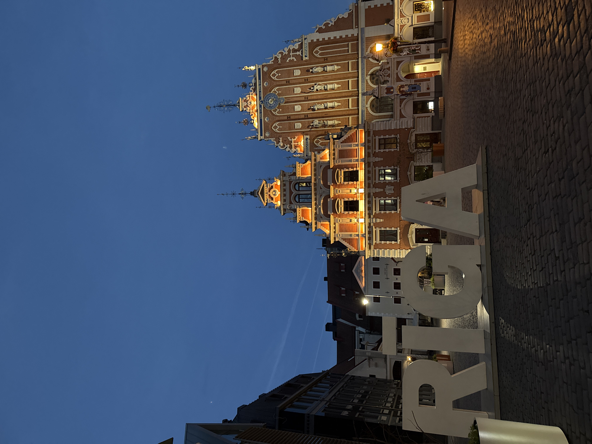 Riga's Old Town at twilight — architecture, roses, and live music
