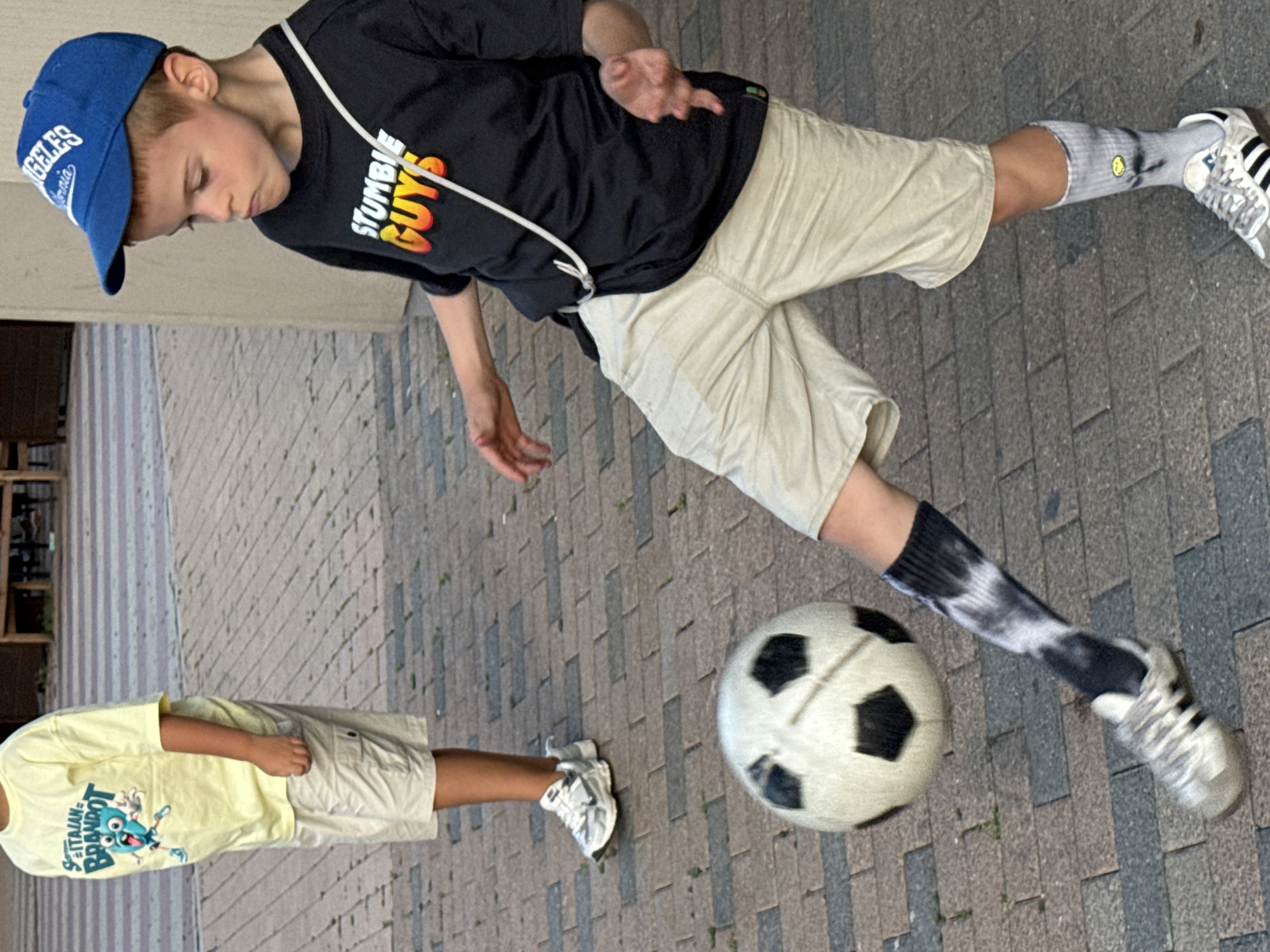 Solo soccer on a Moscow brick plaza, mid-kick