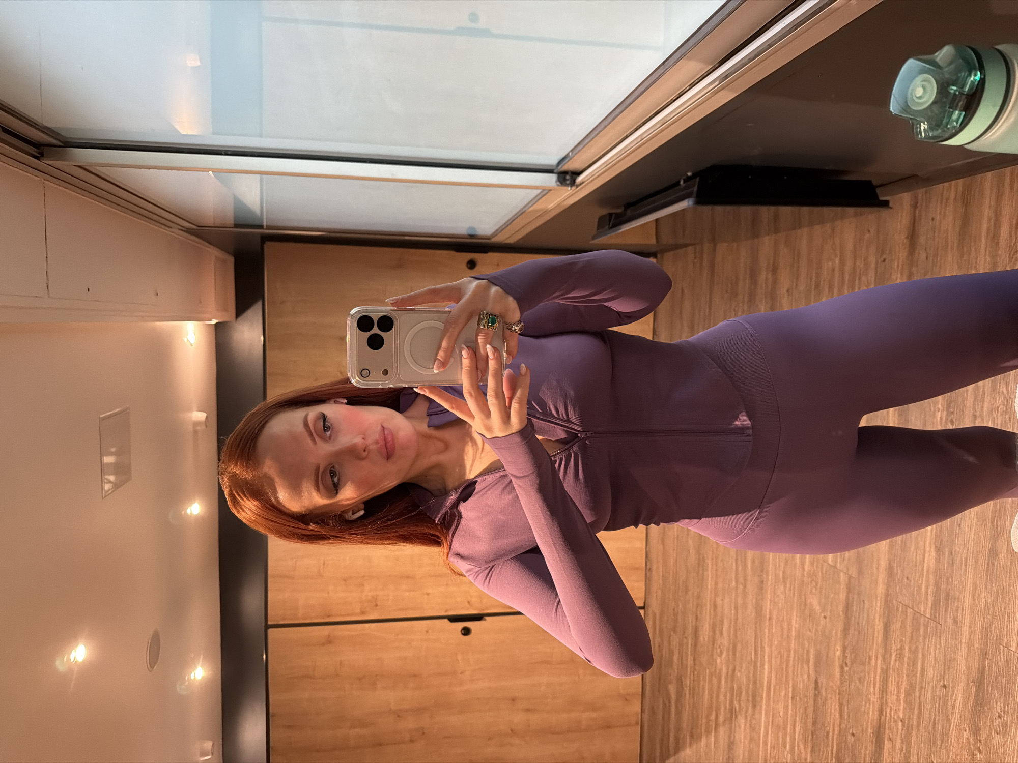 Woman takes gym selfie in purple tracksuit, Paris